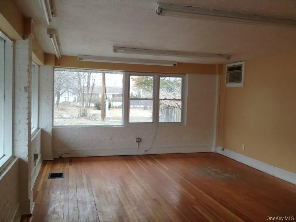 Unit B: Retail/Office space with wood finished floors and large windows Unit B: Retail/Office space with wood finished floors and large windows