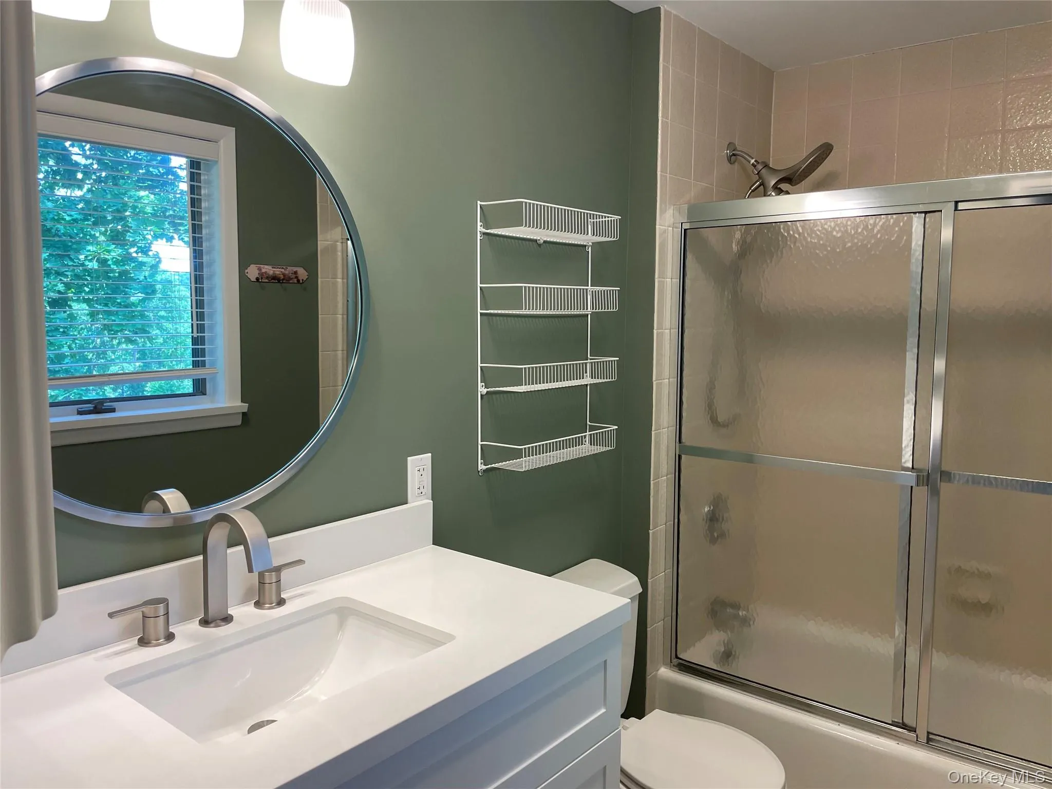 Full bathroom with vanity and shower / bath combination with glass door Full bathroom with vanity and shower / bath combination with glass door