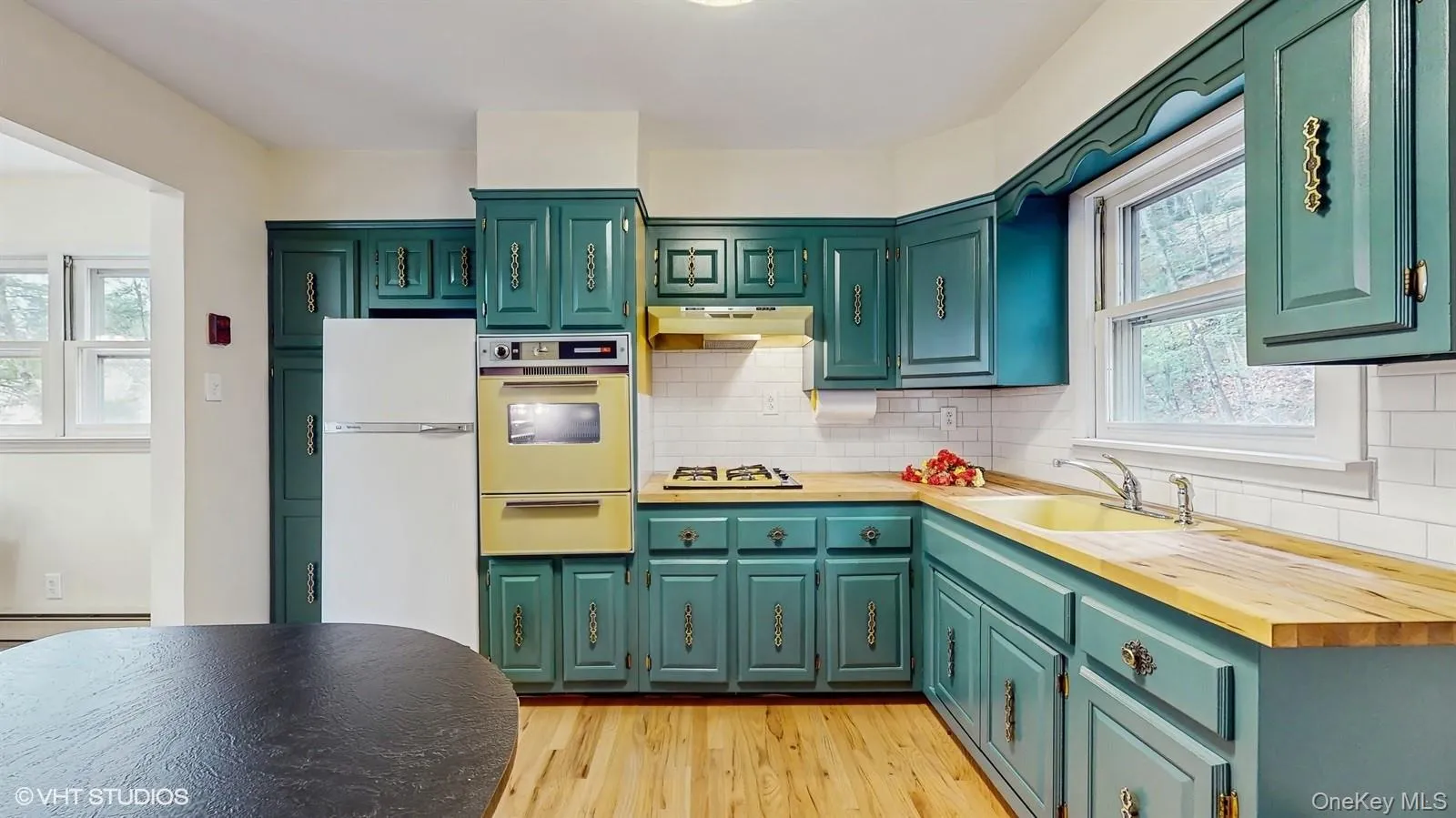 Kitchen featuring green cabinetry with wooden counters Kitchen featuring green cabinetry with wooden counters