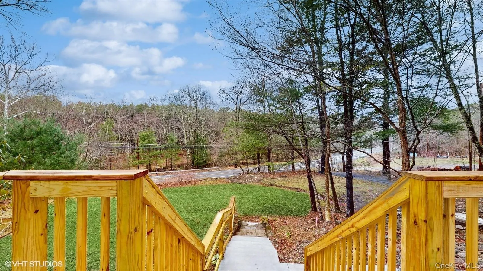 Wooden deck with a lawn and a wooded view Wooden deck with a lawn and a wooded view
