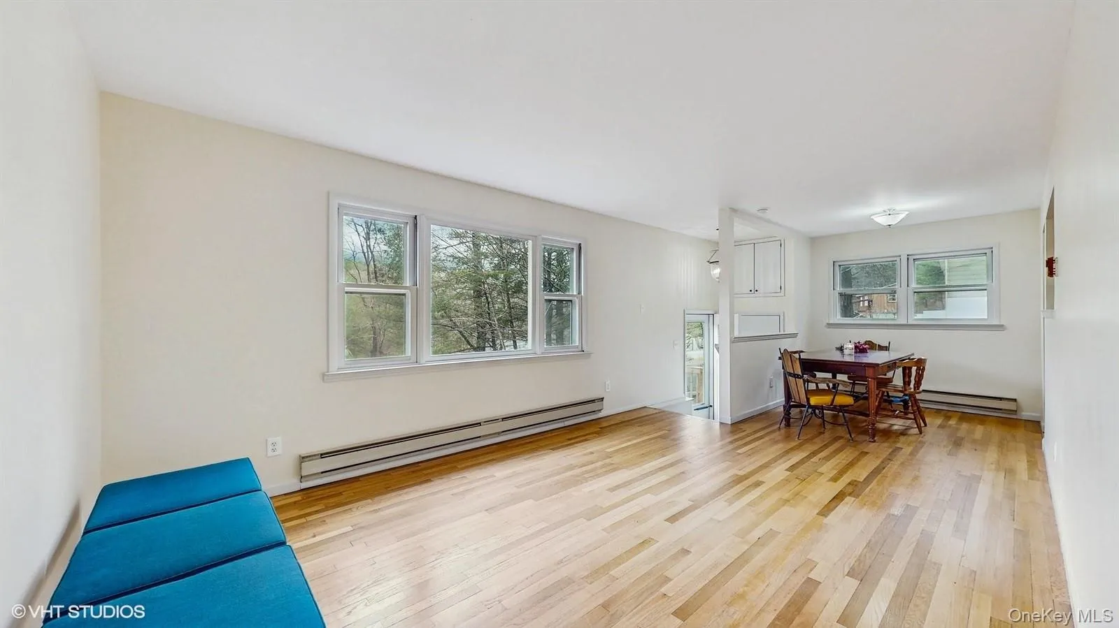Living space with wood finished floors with a wealth of natural light Living space with wood finished floors with a wealth of natural light