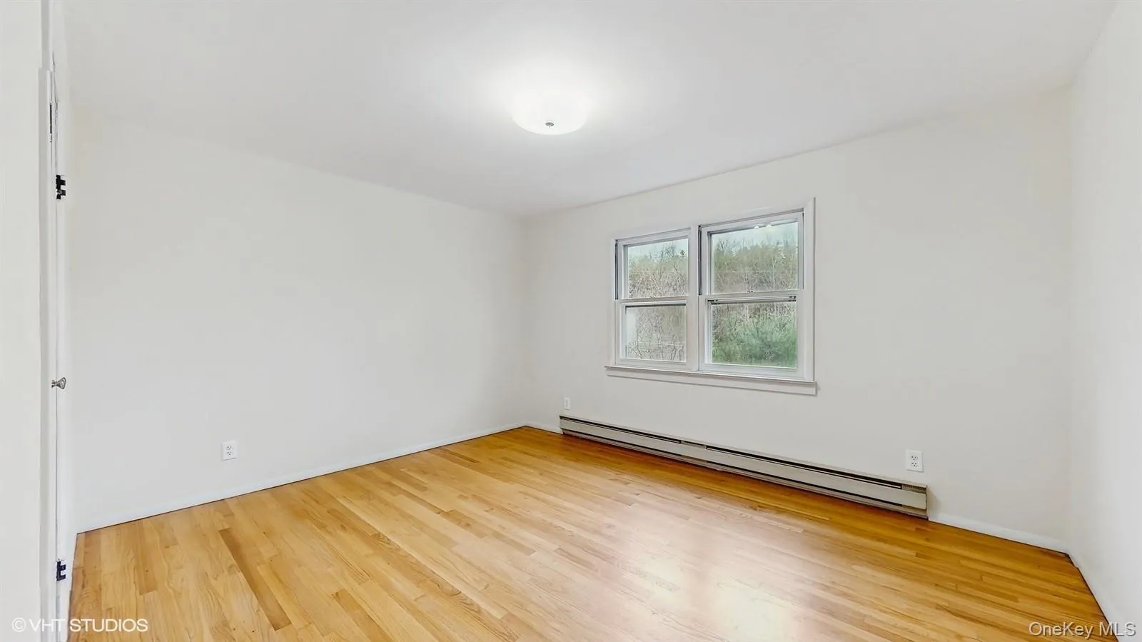 Primary room featuring wood finished floors Primary room featuring wood finished floors