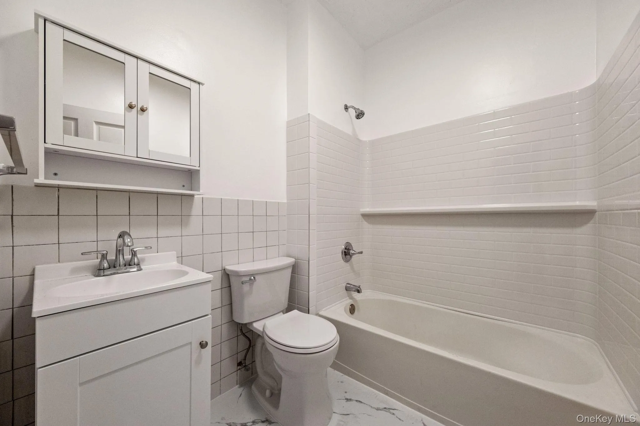 Bright and refreshed bathroom with subway tile surround, updated vanity, and a clean modern aesthetic. Bright and refreshed bathroom with subway tile surround, updated vanity, and a clean modern aesthetic.