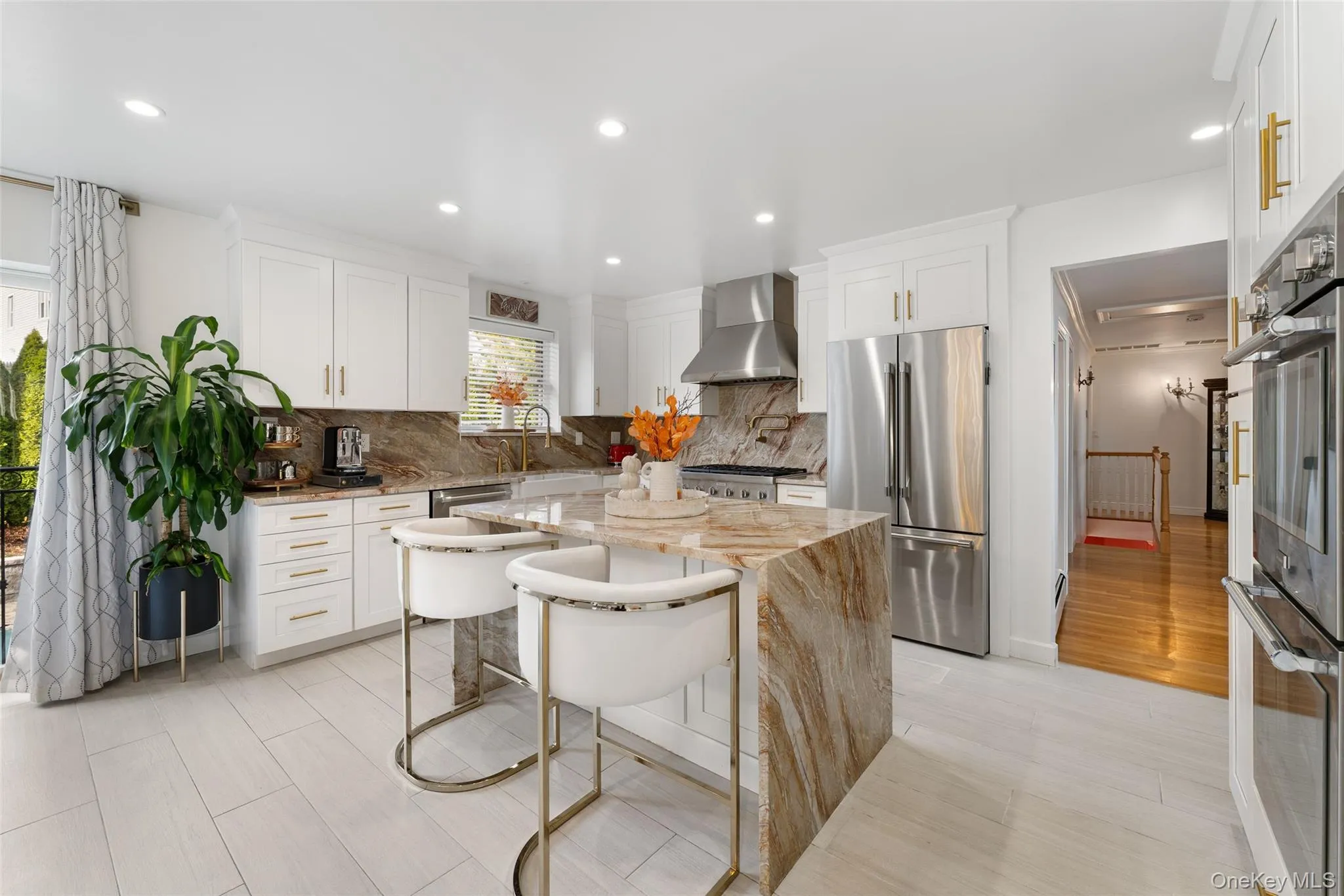 Recently renovated eat in kitchen with center island, granite countertops and Theramodor appliances and pot filler Recently renovated eat in kitchen with center island, granite countertops and Theramodor appliances and pot filler