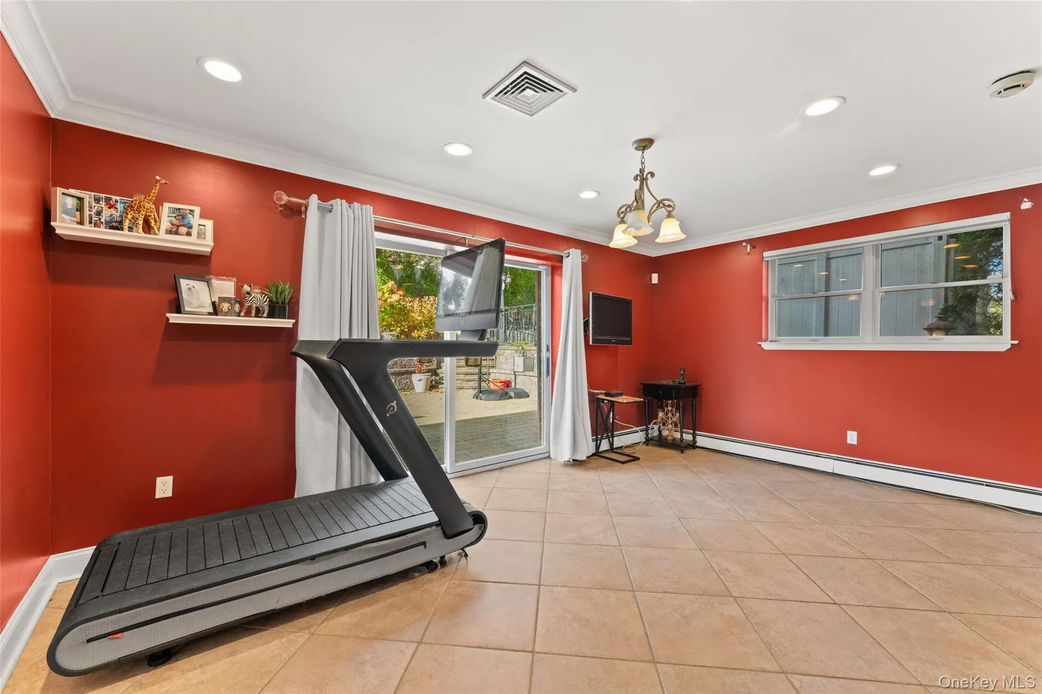 Lower level recreational room with sliders to the patio and backyard Lower level recreational room with sliders to the patio and backyard