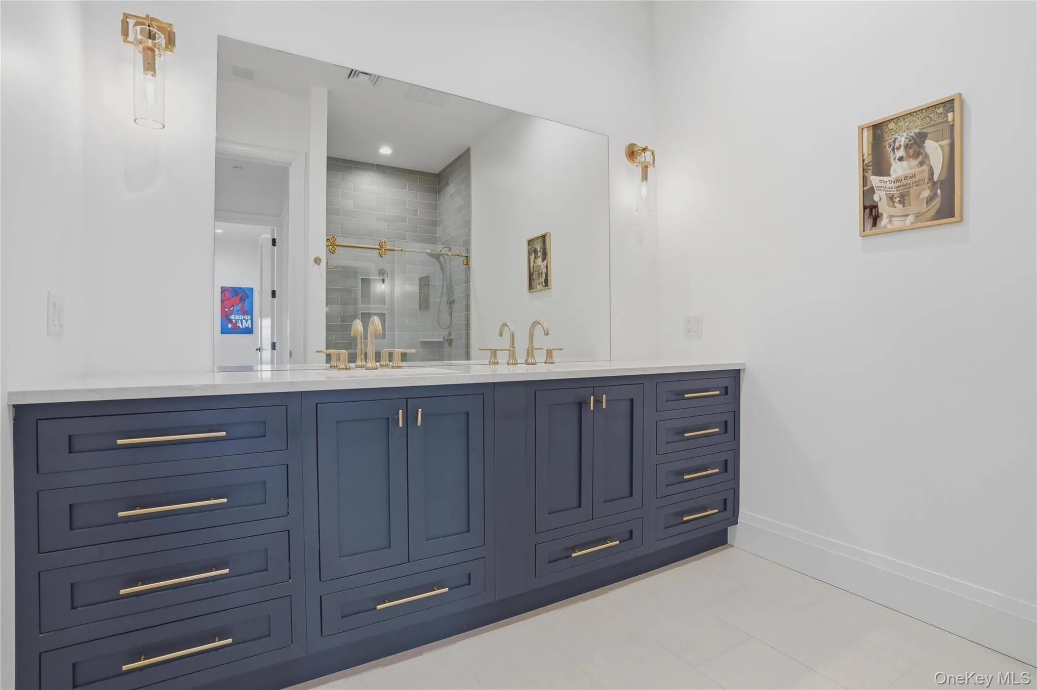 Dual vanity featuring a white countertop, blue cabinetry, and gold-finish hardware Dual vanity featuring a white countertop, blue cabinetry, and gold-finish hardware
