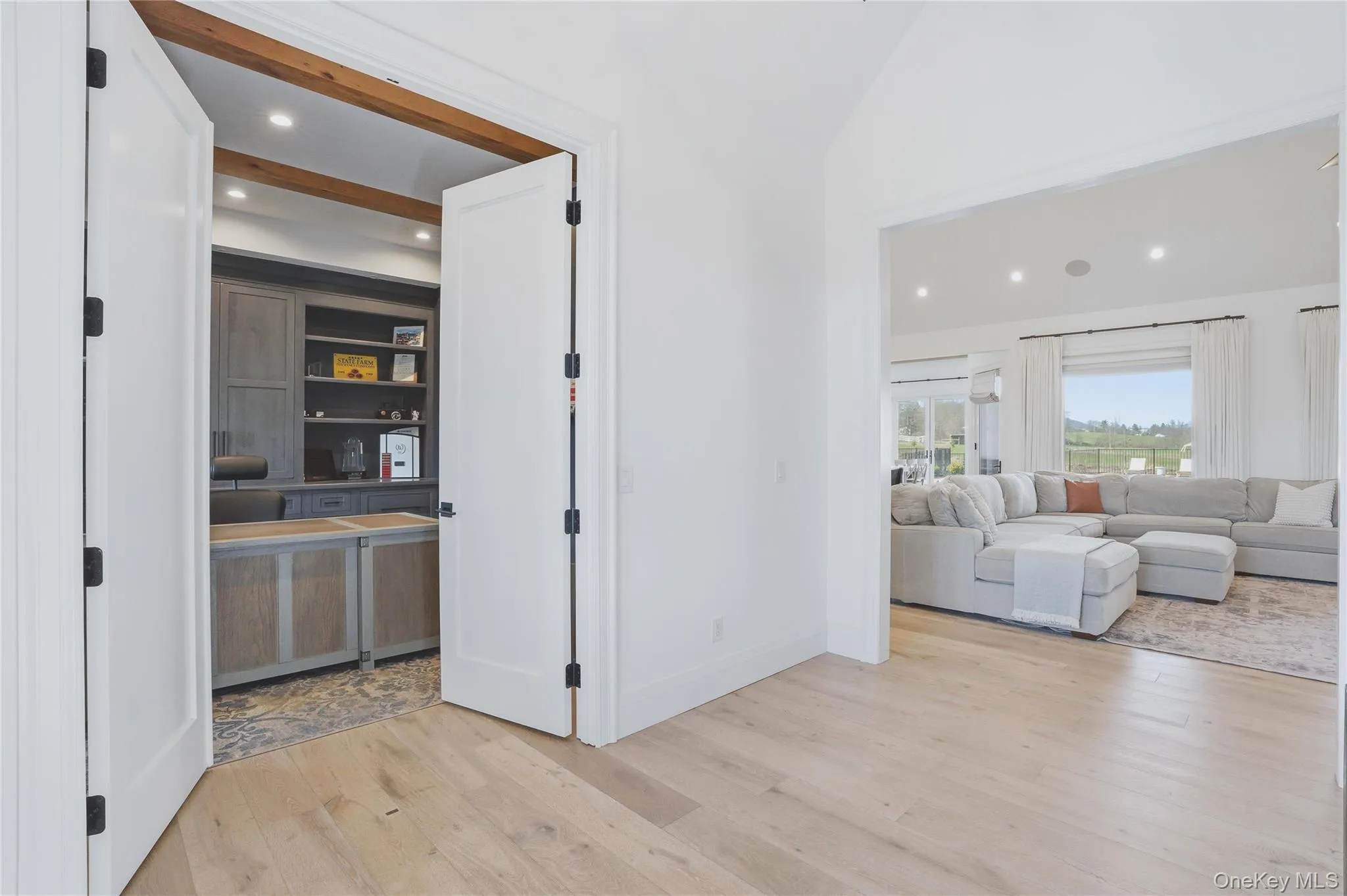 Dedicated office space featuring exposed wood beams, recessed lighting, built-in cabinetry, and a textured area rug Dedicated office space featuring exposed wood beams, recessed lighting, built-in cabinetry, and a textured area rug