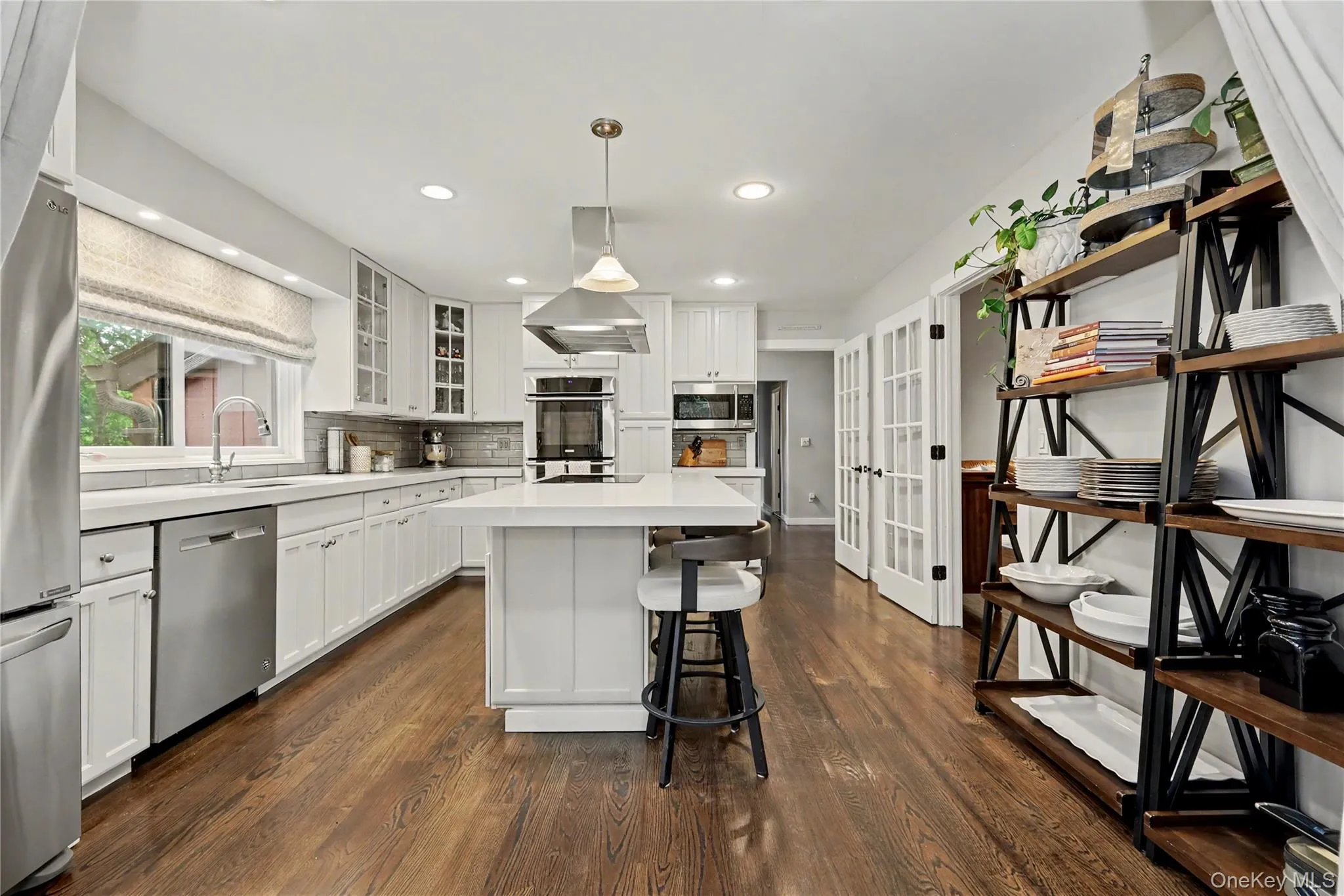 Chefs will be filled with joy to find a double oven with warming draw, built in microwave, cooktop and hood over center island. Chefs will be filled with joy to find a double oven with warming draw, built in microwave, cooktop and hood over center island.