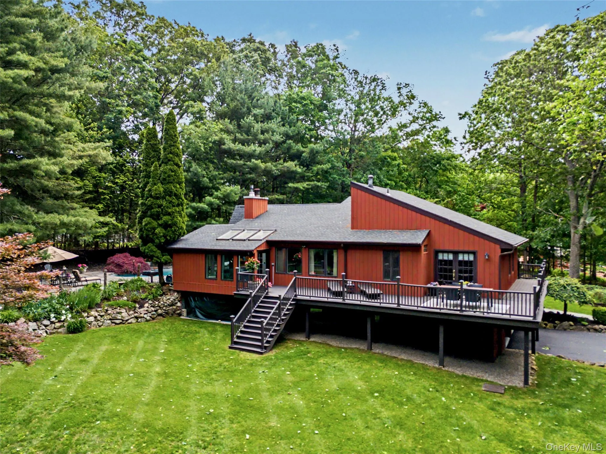 Wrap around deck surrounded by nature providing a tranquil setting with exceptional privacy and picturesque views of surrounding landscaping. Wrap around deck surrounded by nature providing a tranquil setting with exceptional privacy and picturesque views of surrounding landscaping.