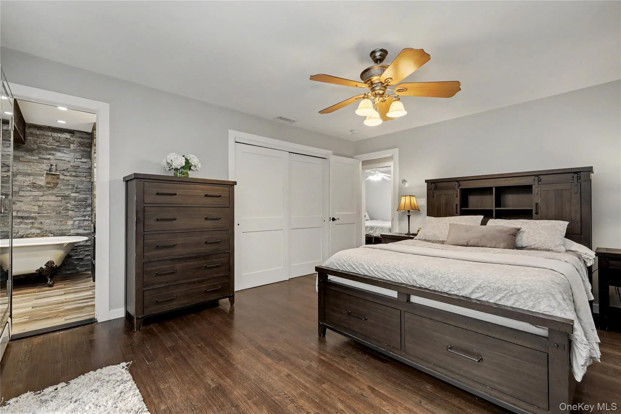 Primary bedroom with rustic custom primary bathroom with claw foot soaking tub. Primary bedroom with rustic custom primary bathroom with claw foot soaking tub.