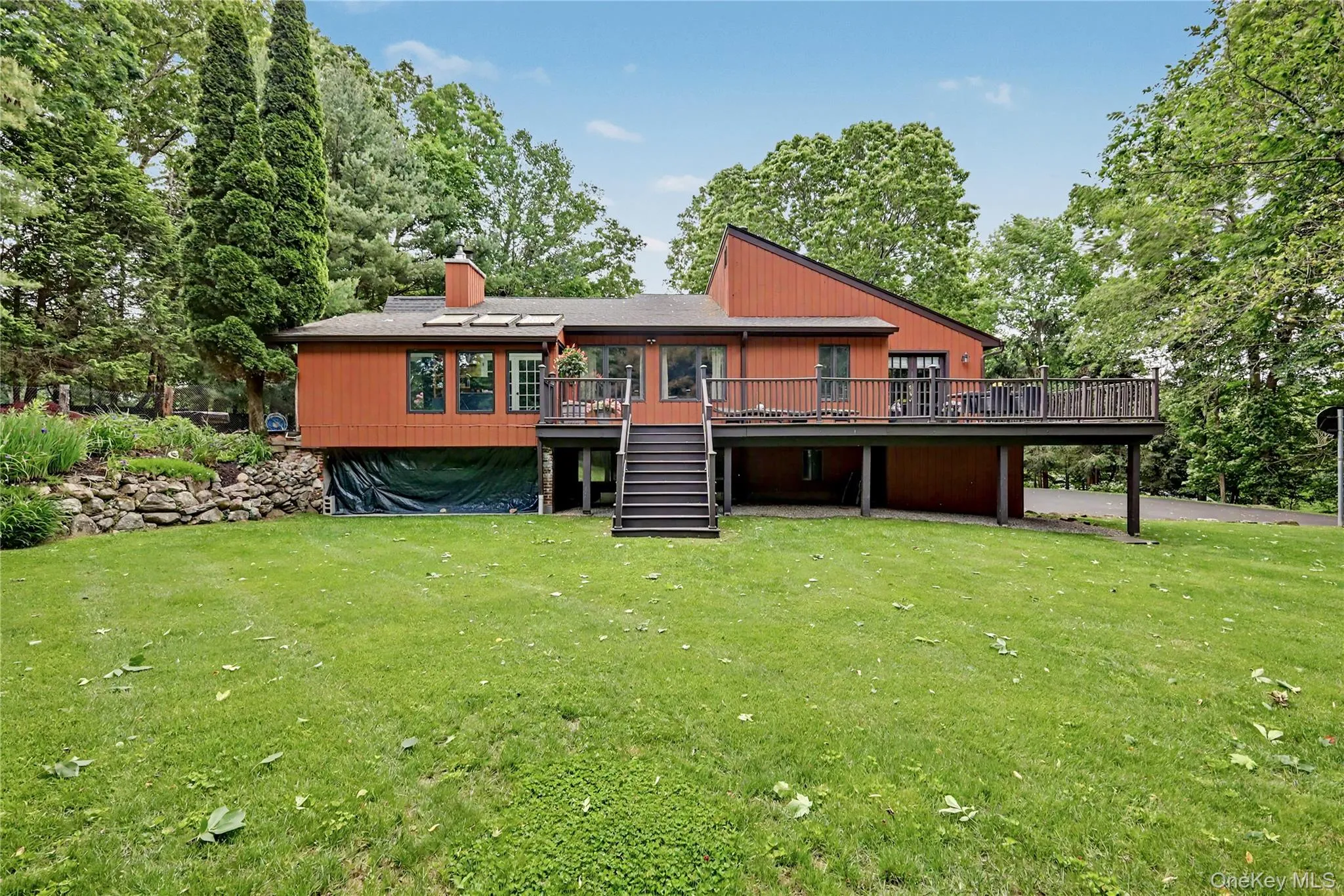 Beautiful lush level backyard. Storage room below deck. Beautiful lush level backyard. Storage room below deck.