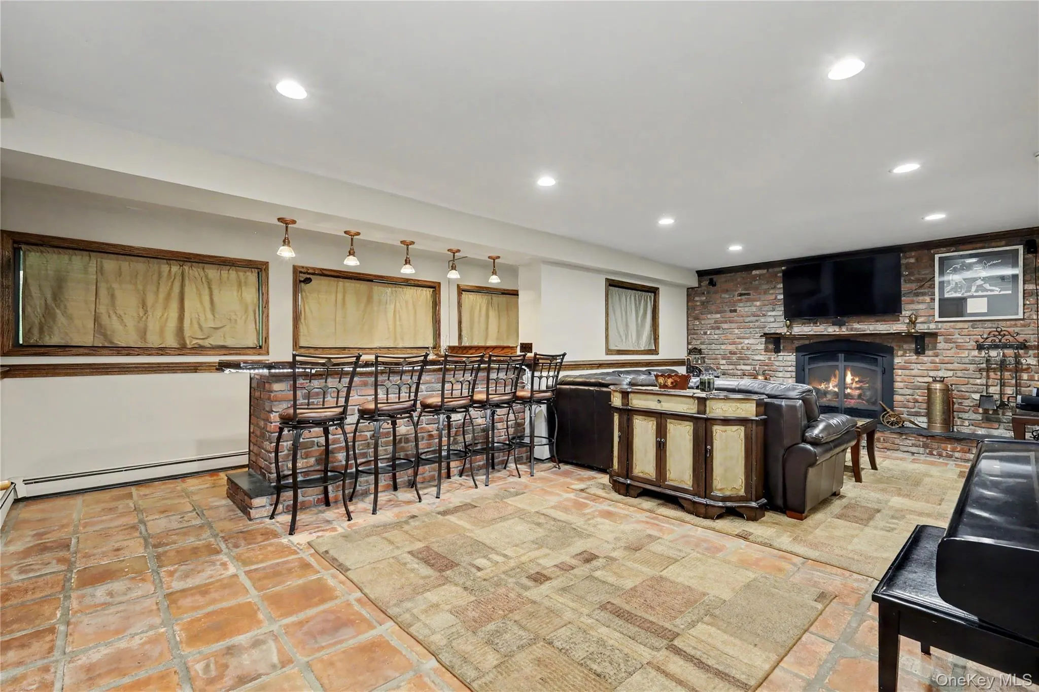 Spacious family room features fireplace and hand crafted black walnut built in bar, creating the ultimate space for entertaining, game nights, and relaxing with friends and family. Spacious family room features fireplace and hand crafted black walnut built in bar, creating the ultimate space for entertaining, game nights, and relaxing with friends and family.