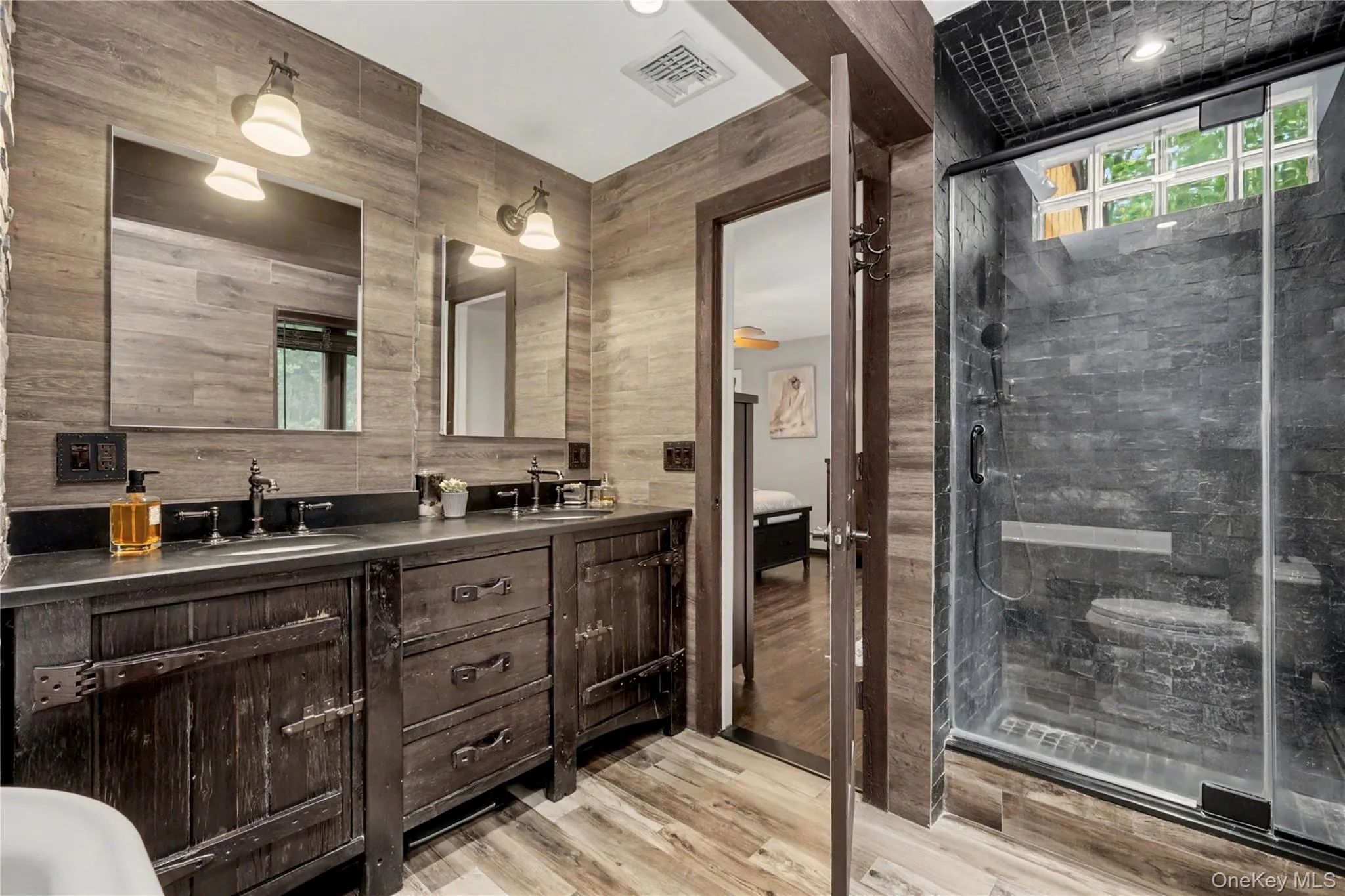 Rustic bathroom with stone shower, double vanity with plenty of storage. Rustic bathroom with stone shower, double vanity with plenty of storage.