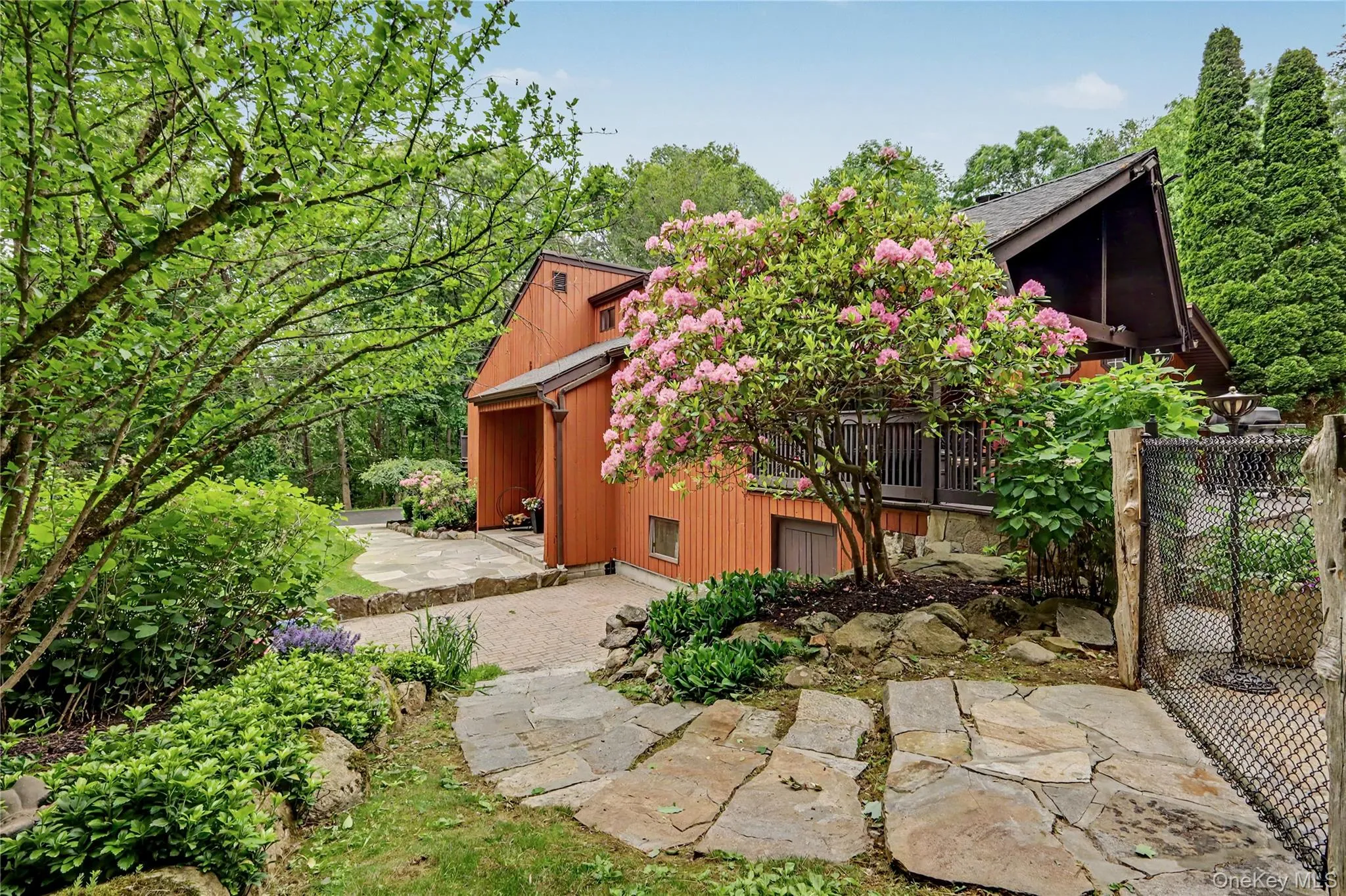 Front patio with stone steps through natural gardens leading to pool. Front patio with stone steps through natural gardens leading to pool.