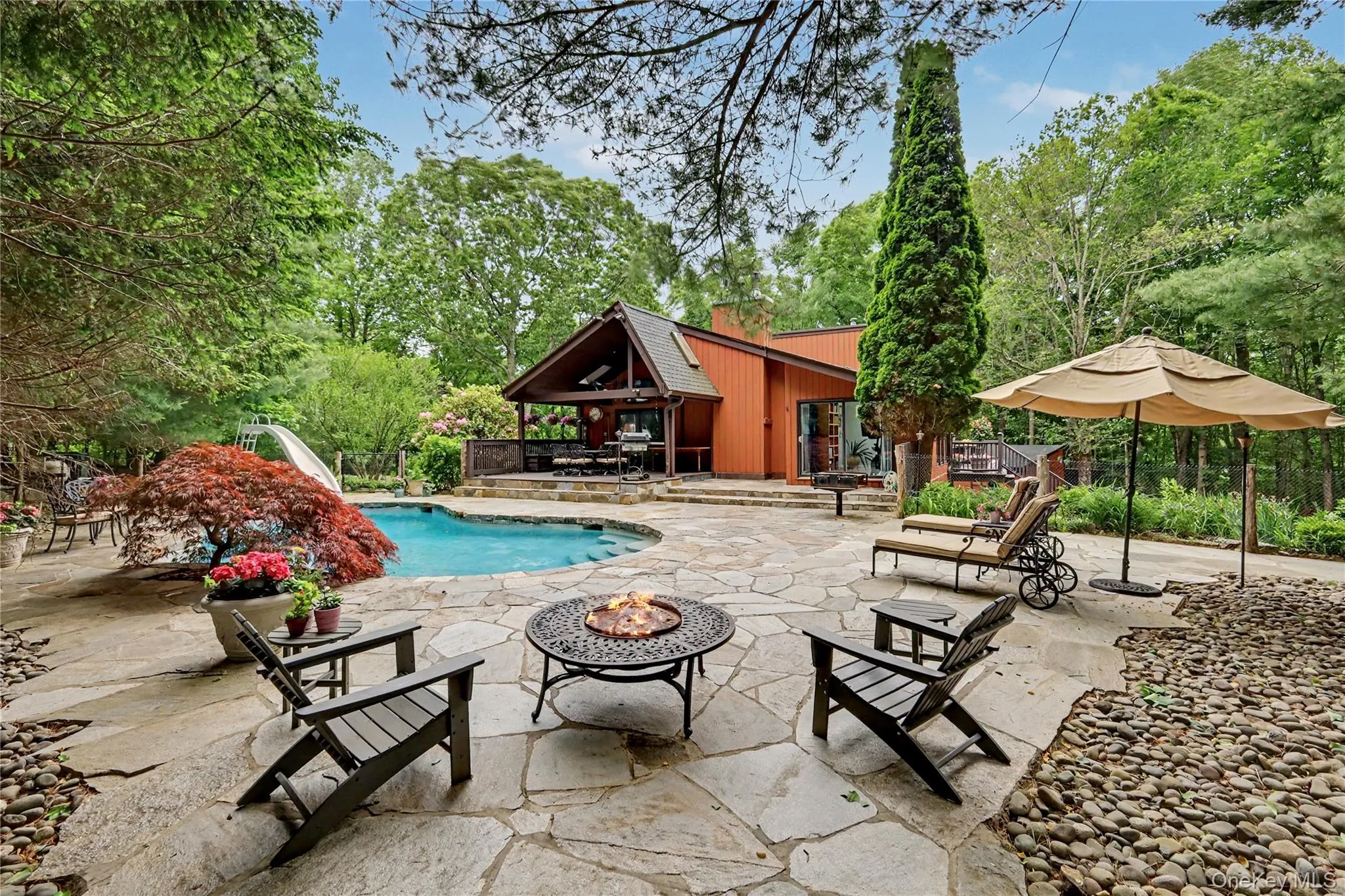 Heated gunite pool off covered mahogany deck serves as a private outdoor oasis, offering the perfect setting for al fresco dining, entertaining guest, or enjoying the tranquility of your own secluded retreat. Heated gunite pool off covered mahogany deck serves as a private outdoor oasis, offering the perfect setting for al fresco dining, entertaining guest, or enjoying the tranquility of your own secluded retreat.