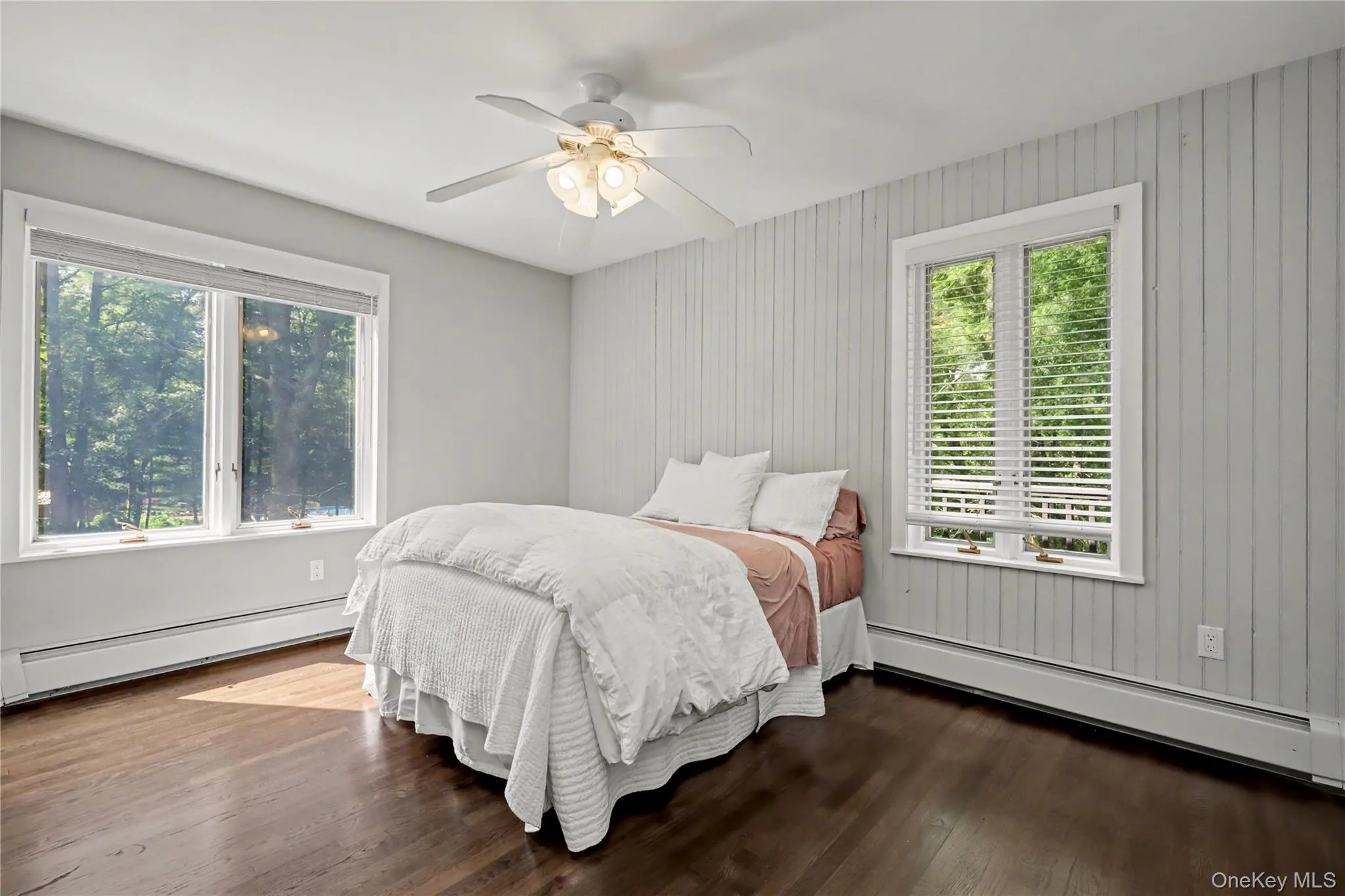 Main Floor bedroom with ceiling fan and hardwood floors. Main Floor bedroom with ceiling fan and hardwood floors.