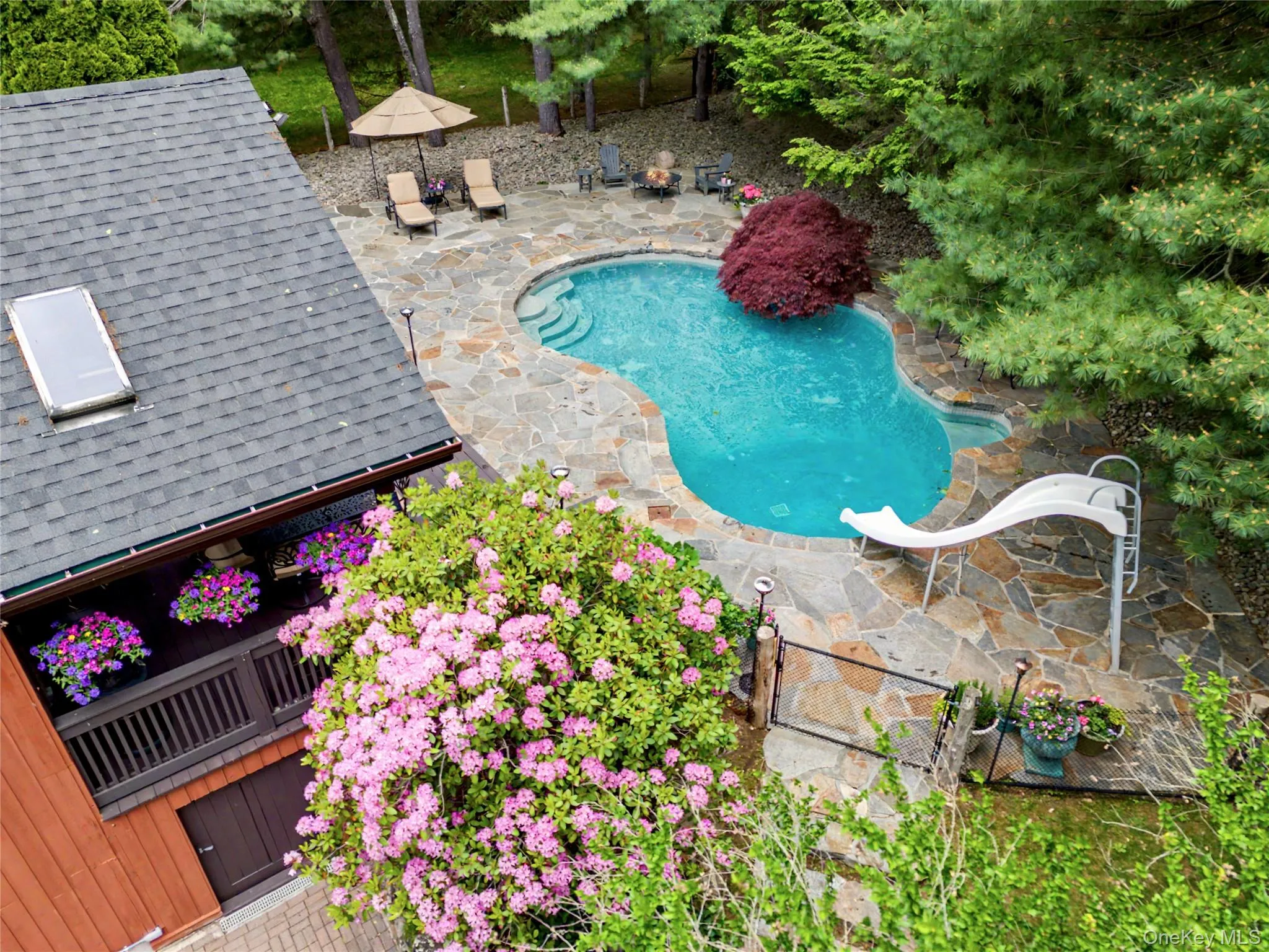 In ground heated Gunite pool with slide. In ground heated Gunite pool with slide.