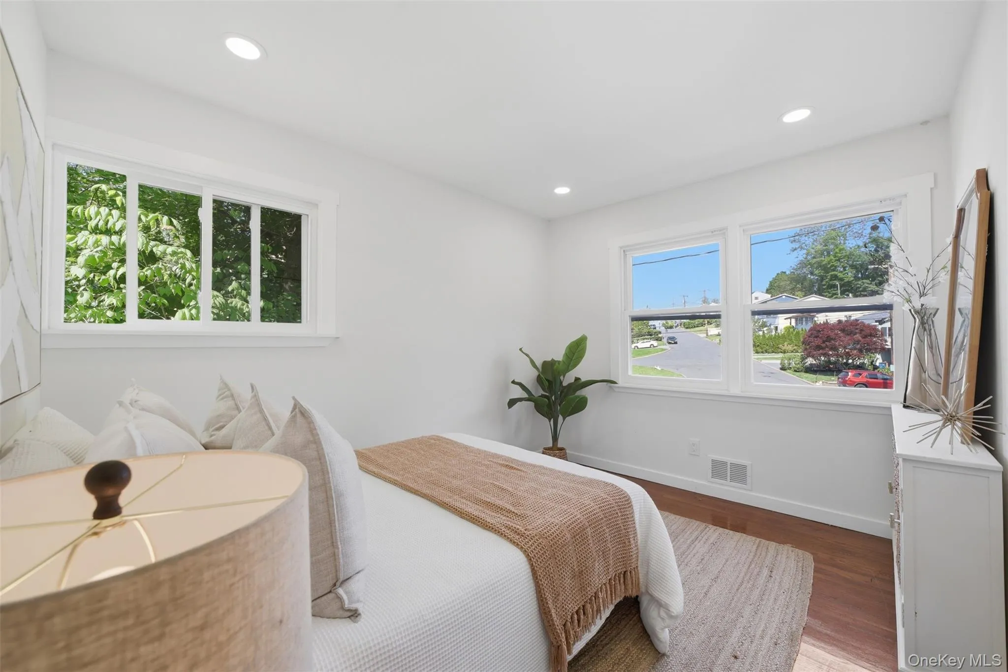 Bright interior with recessed lighting and warm wood-finish flooring Bright interior with recessed lighting and warm wood-finish flooring