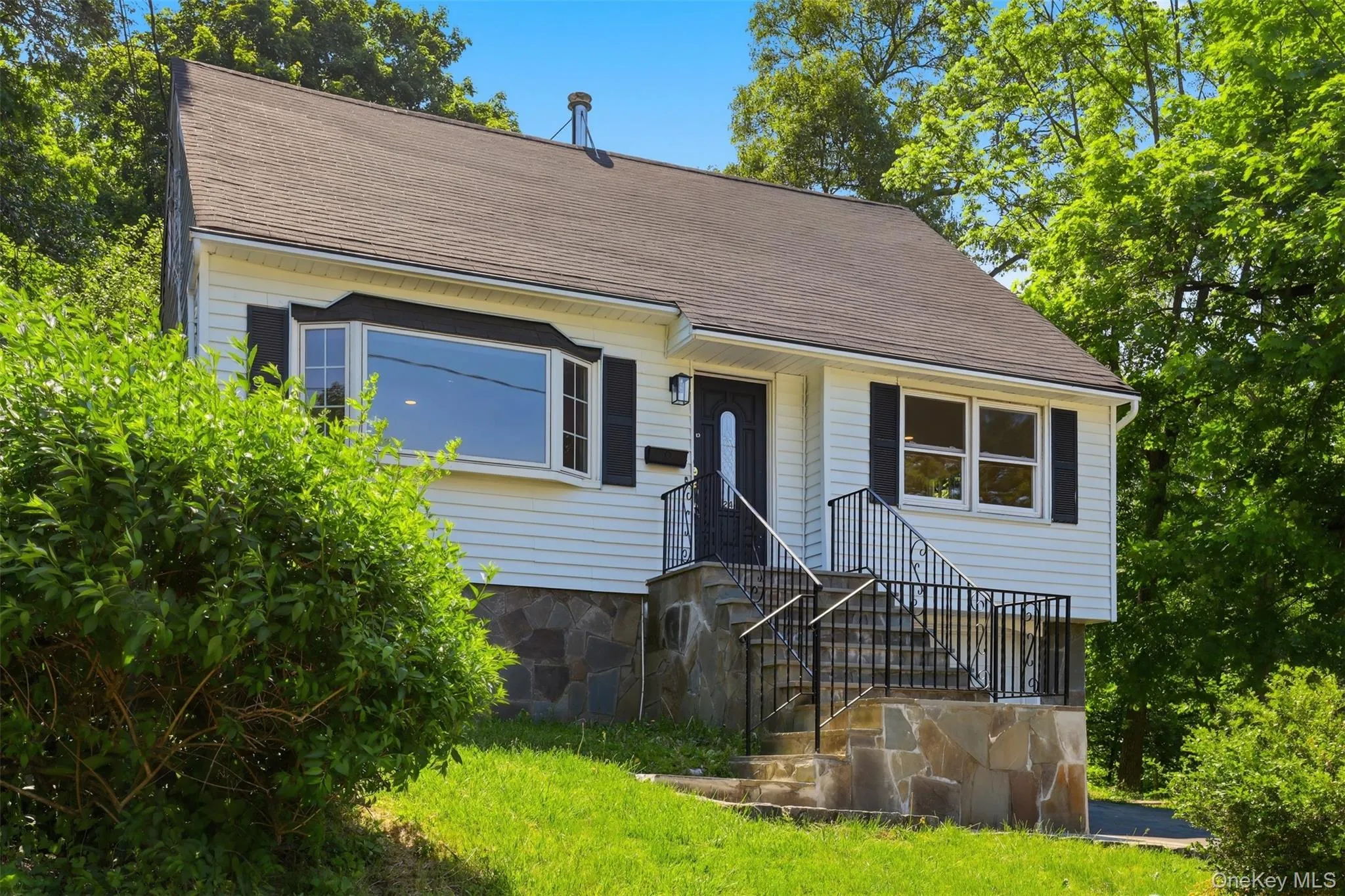 White siding exterior with a dark shingle roof White siding exterior with a dark shingle roof
