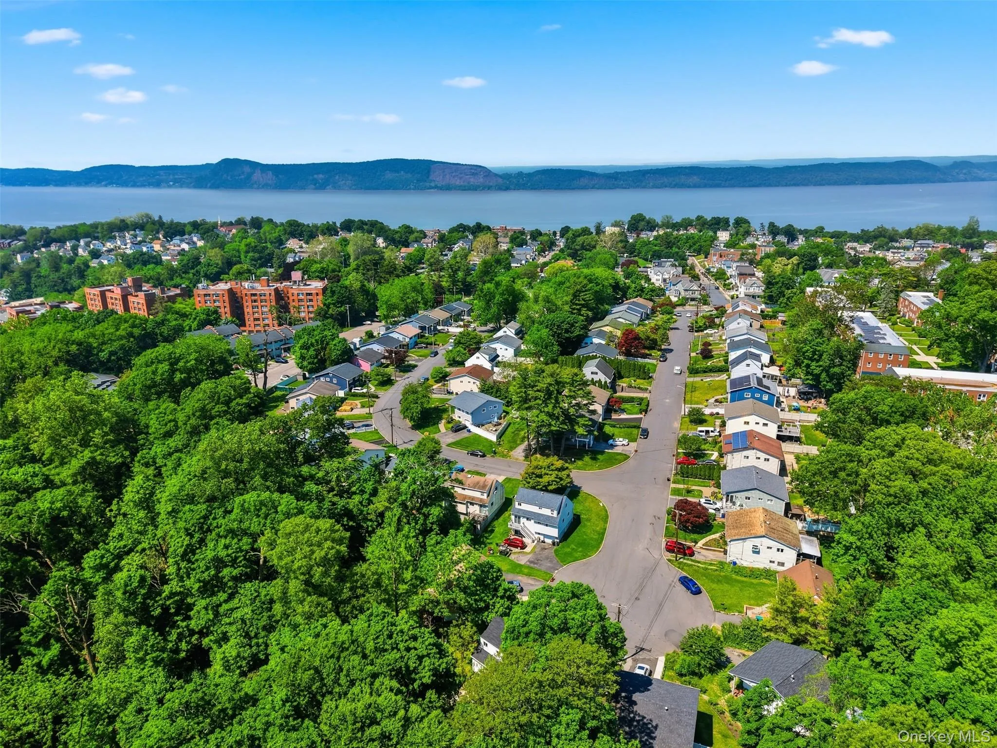 Residential neighborhood with a prominent body of water and distant landforms Residential neighborhood with a prominent body of water and distant landforms