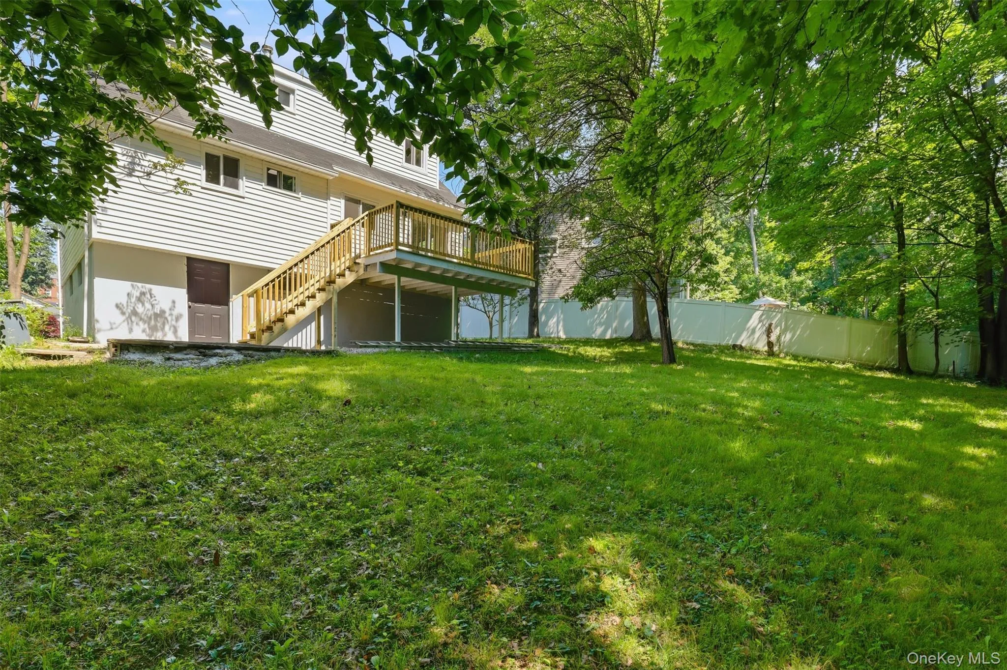 Expansive grassy yard with mature trees Expansive grassy yard with mature trees