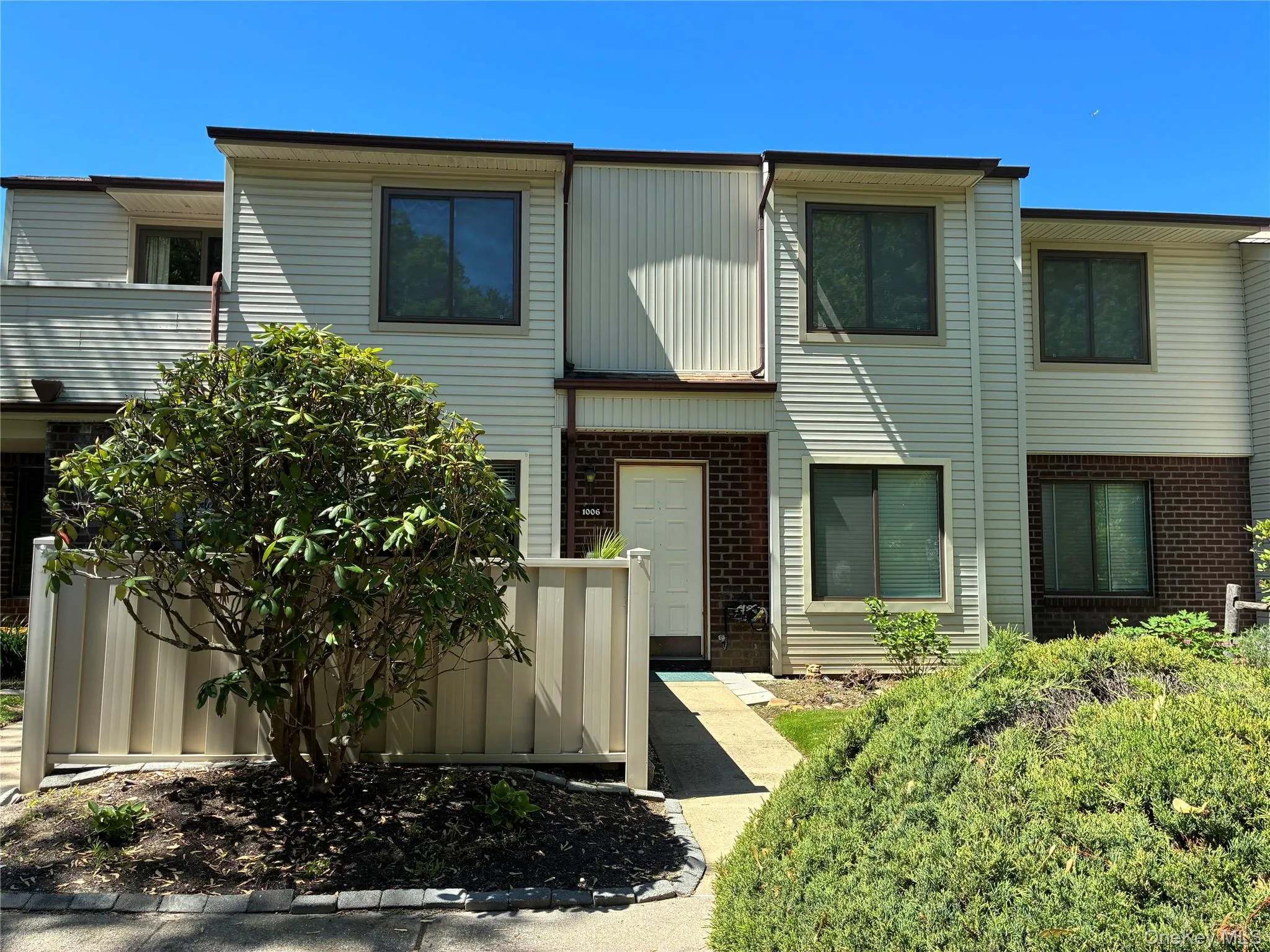 Outside front view of UPPER unit condo showing attached Balcony to the left Outside front view of UPPER unit condo showing attached Balcony to the left
