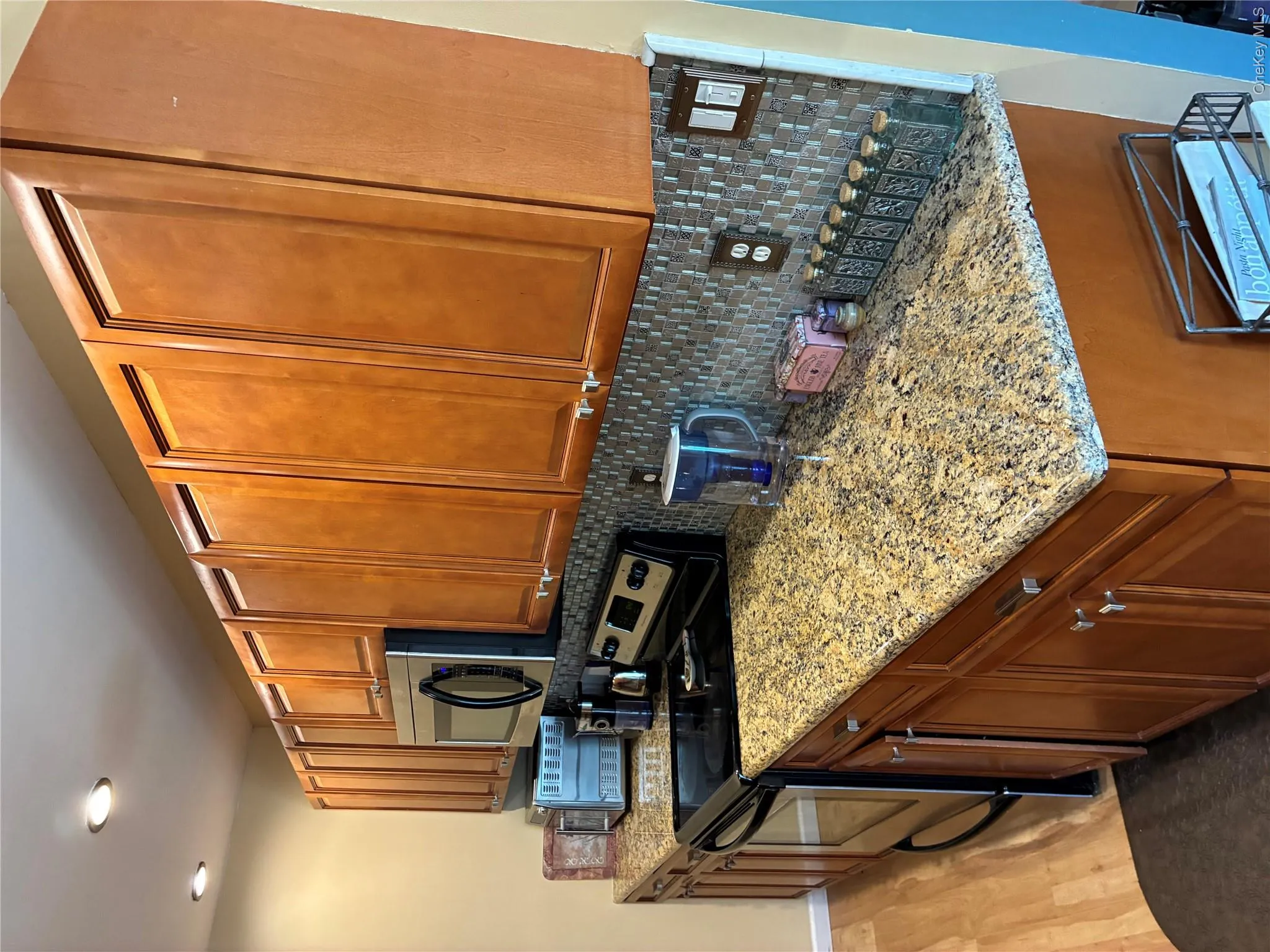Updated Galley kitchen with plenty of cabinets for storage. View shows electric stove on right side. Also Full length size Granite Counter tops on both sides! Updated Galley kitchen with plenty of cabinets for storage. View shows electric stove on right side. Also Full length size Granite Counter tops on both sides!