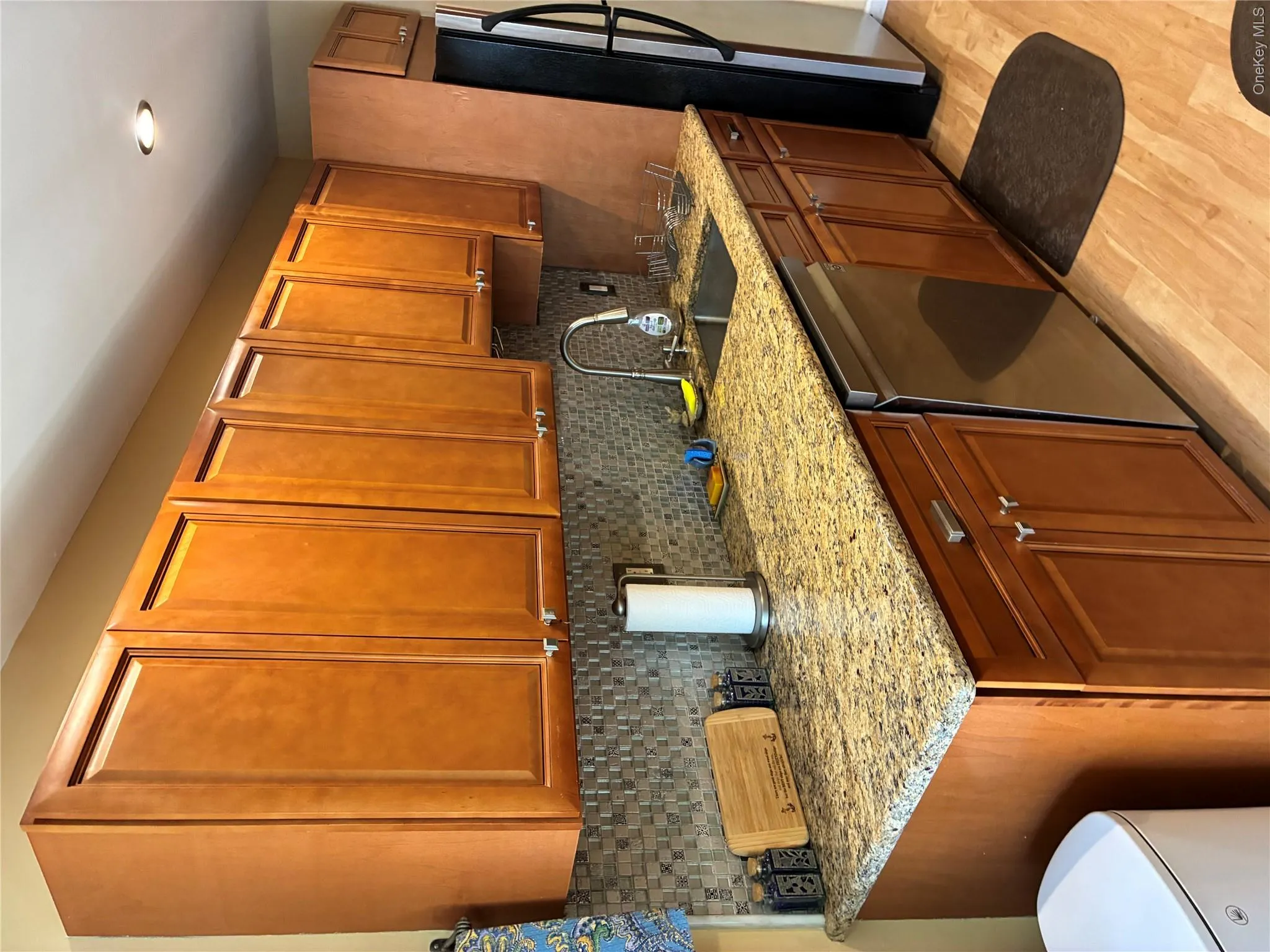 Updated Galley kitchen with plenty of cabinets for storage. View shows Dishwasher and Sink on left side. Also Full length size Granite Counter tops on both sides! Updated Galley kitchen with plenty of cabinets for storage. View shows Dishwasher and Sink on left side. Also Full length size Granite Counter tops on both sides!