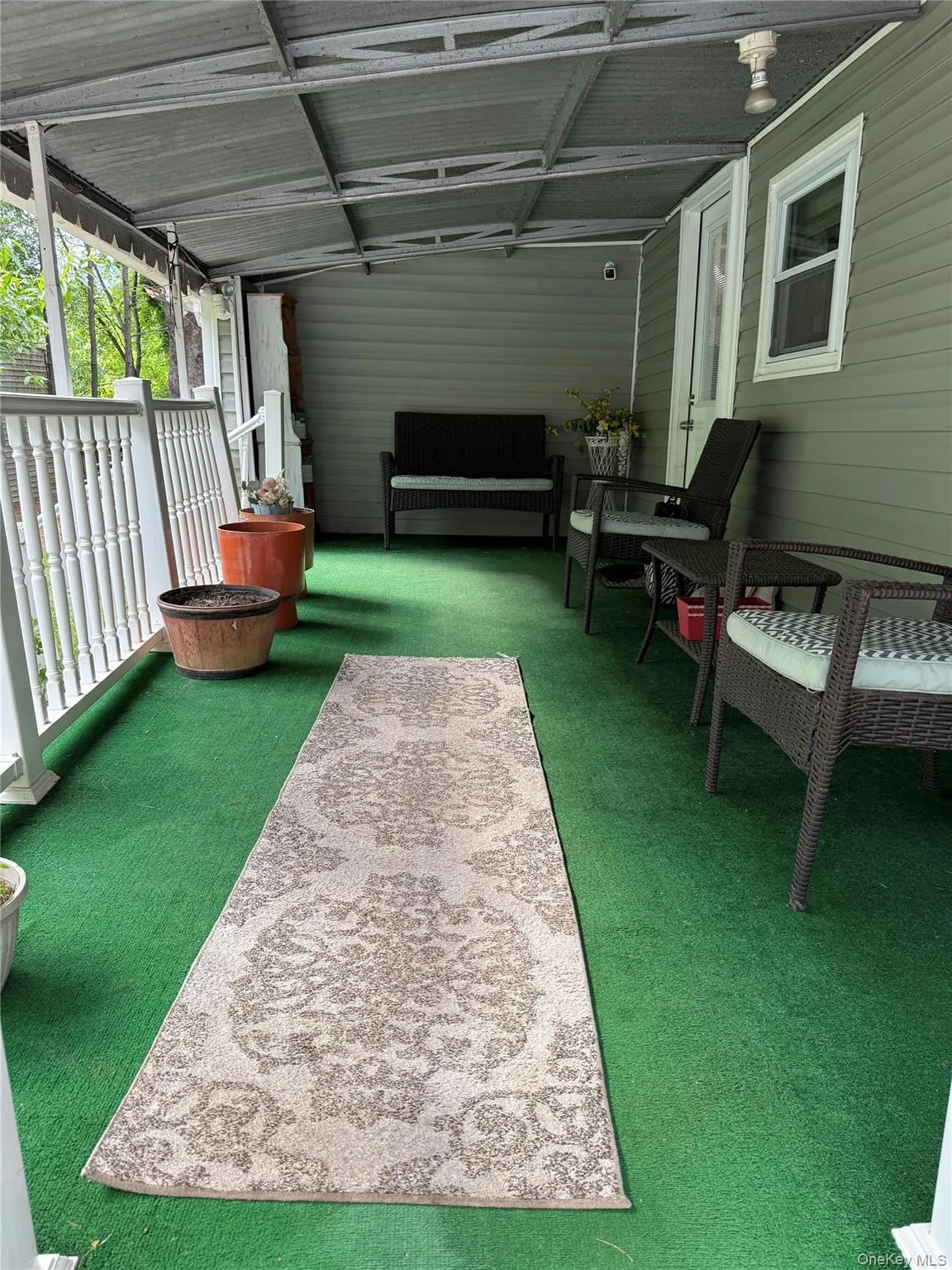 Porch facing garden with two separate stairs leading to the front door. Porch facing garden with two separate stairs leading to the front door.