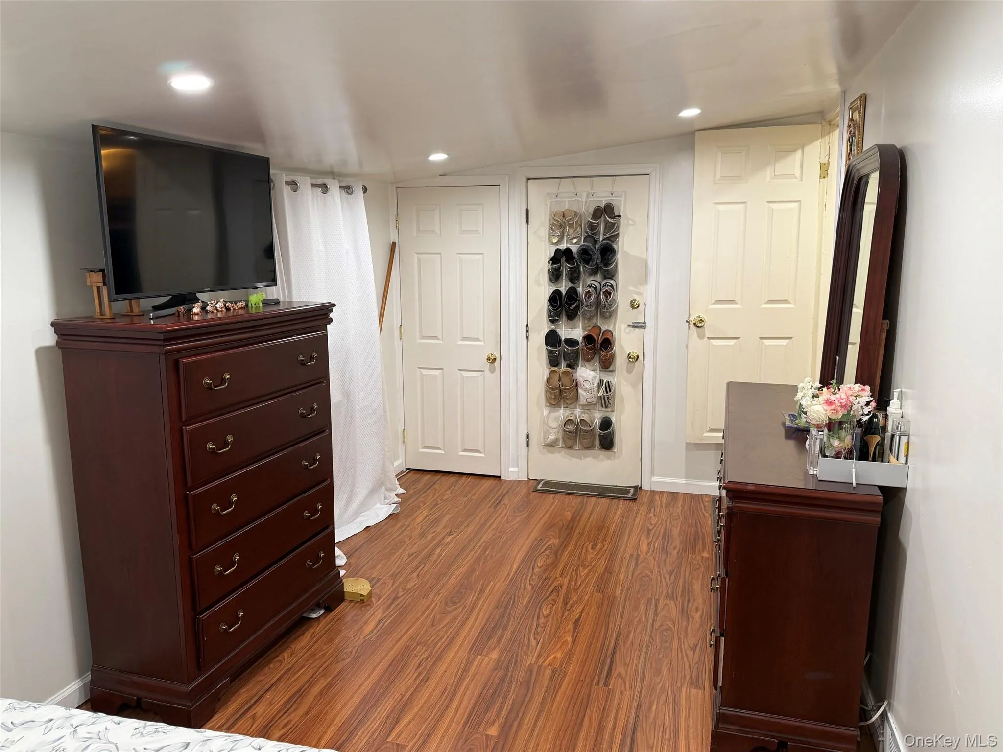 Hardwood-finish flooring throughout, featuring recessed ceiling lights and white trim Hardwood-finish flooring throughout, featuring recessed ceiling lights and white trim