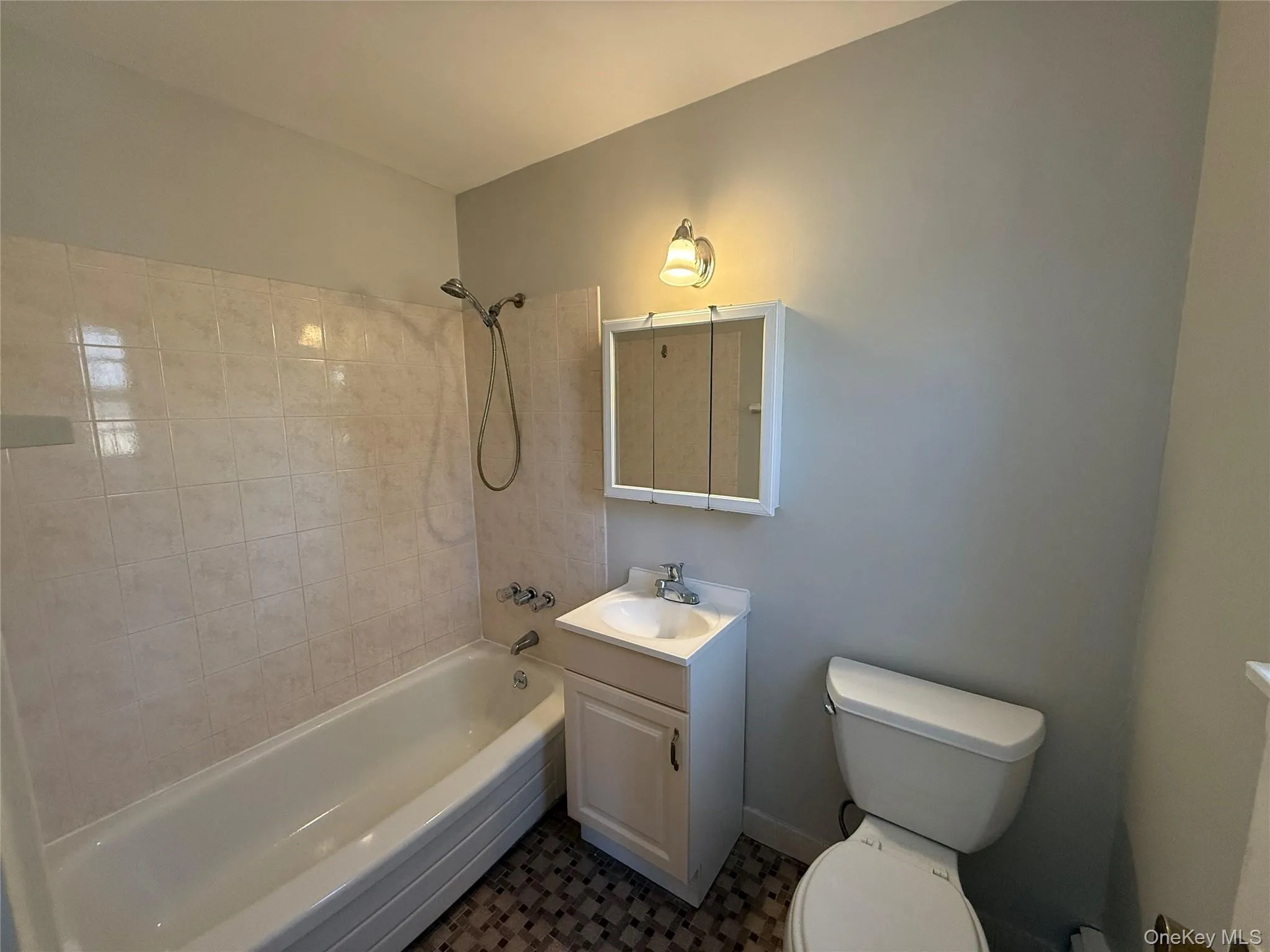 Full bath with shower / bathing tub combination, vanity, and toilet Full bath with shower / bathing tub combination, vanity, and toilet