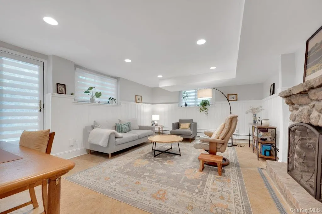 Lower level large multi purpose room with door to back and fireplace Lower level large multi purpose room with door to back and fireplace