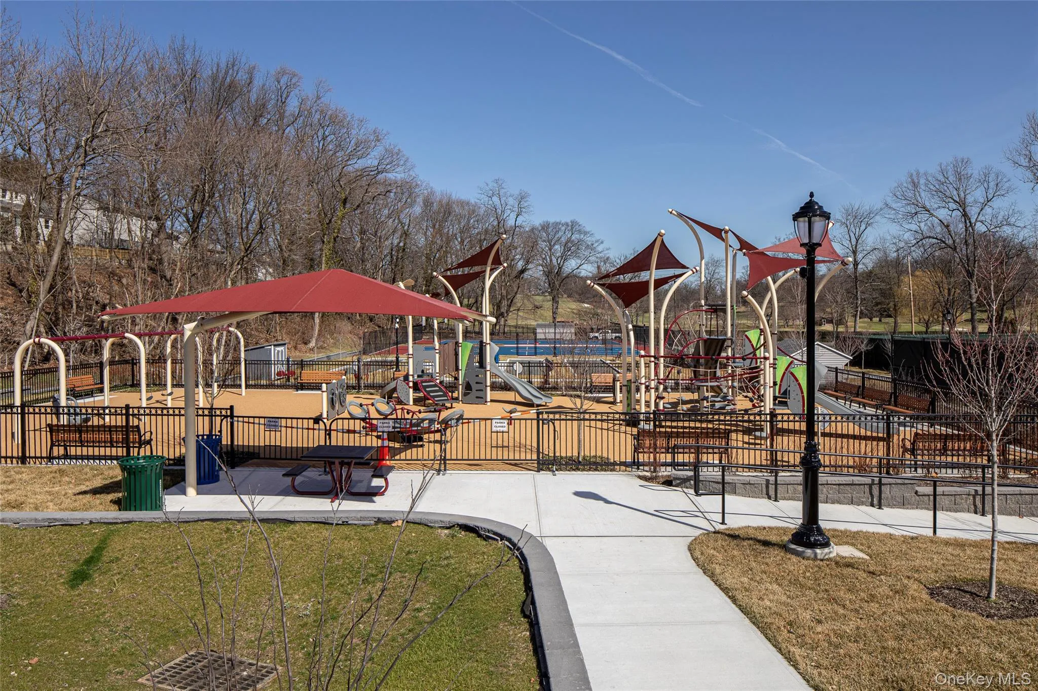 Leewood Park playground area featuring a yard and fence. Leewood Park playground area featuring a yard and fence.