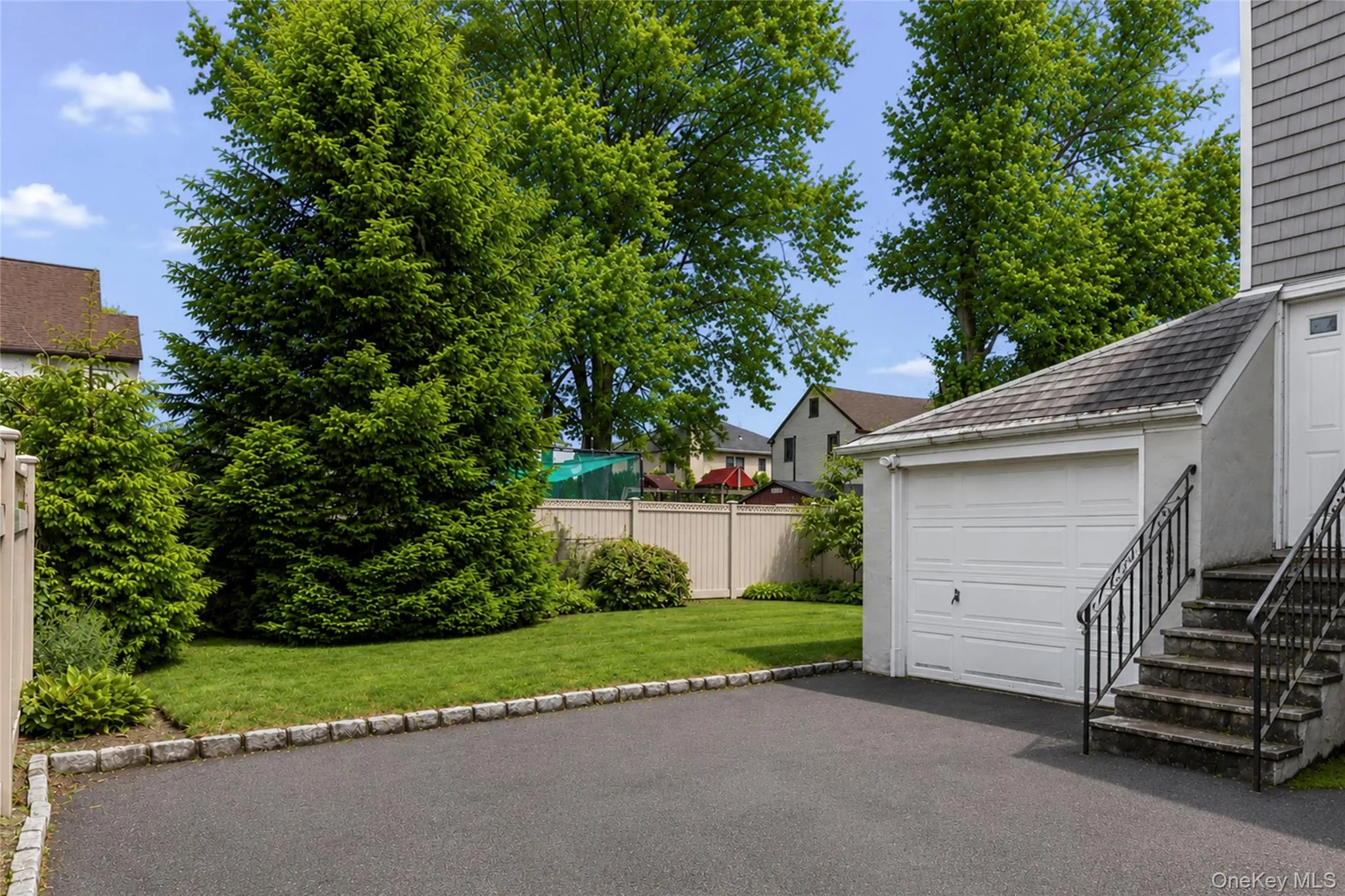 View of driveway to one car attached garage. View of driveway to one car attached garage.
