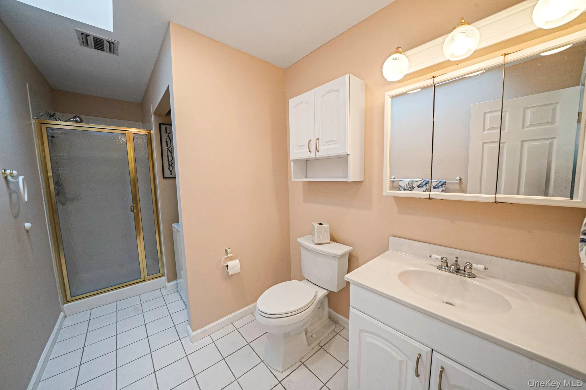 Hall Bath, tile floor, single sink vanity, stall shower, washer/dryer Hall Bath, tile floor, single sink vanity, stall shower, washer/dryer