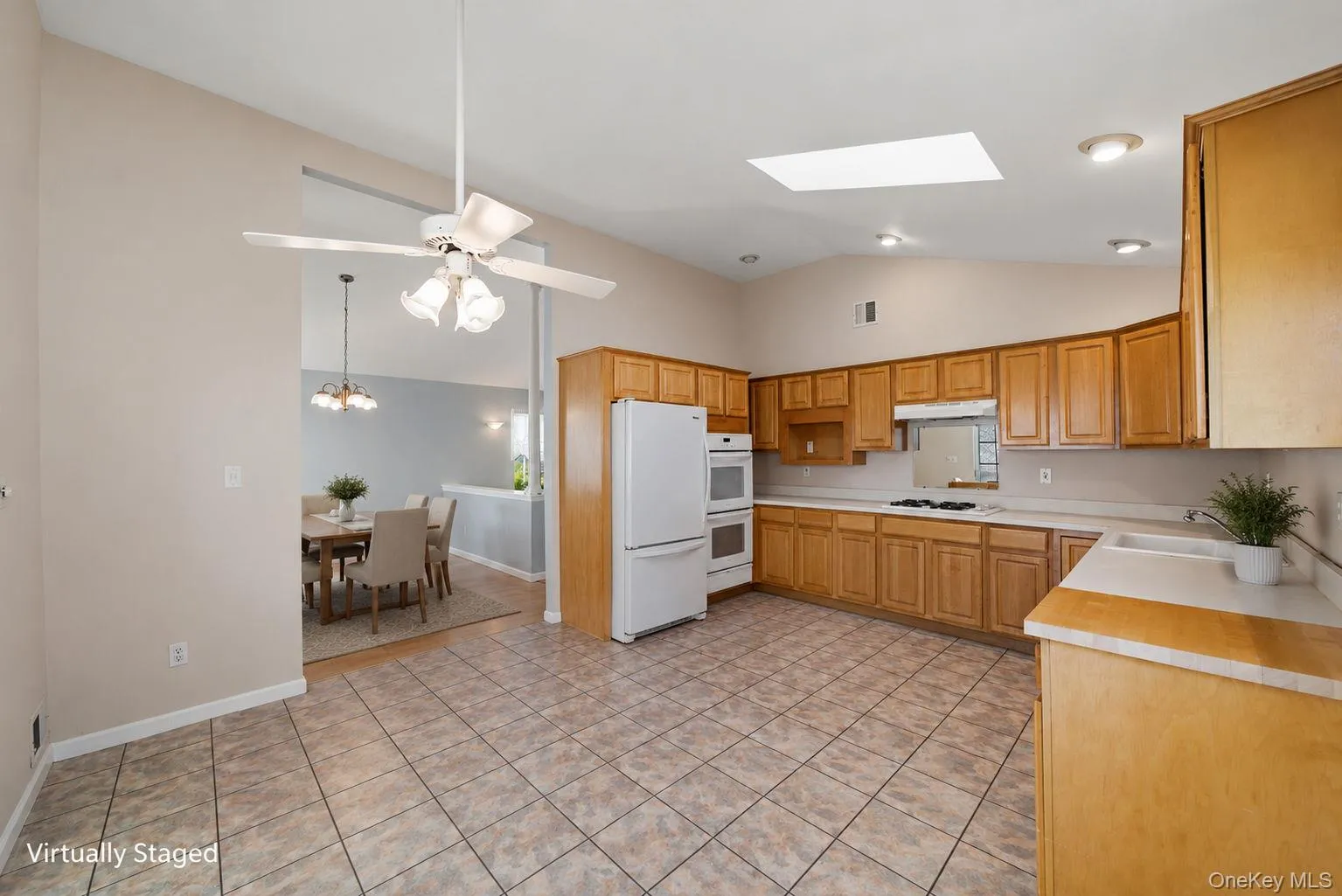 Open kitchen with soaring ceiling tile floor, wood cabinetry Open kitchen with soaring ceiling tile floor, wood cabinetry