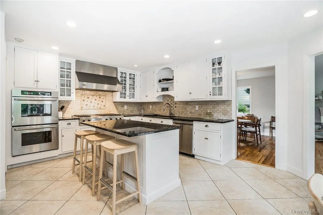 Chef's kitchen with stainless steel appliances and center island with enough room to seat three! Chef's kitchen with stainless steel appliances and center island with enough room to seat three!