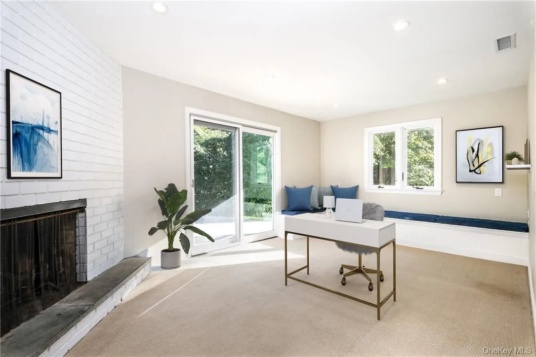 Large study in lower level with fireplace and sliding doors to the yard - the perfect home office! (Digitally staged) Large study in lower level with fireplace and sliding doors to the yard - the perfect home office! (Digitally staged)