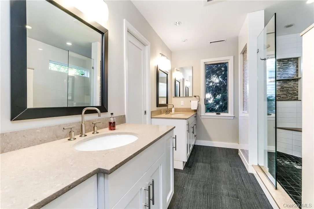 Luxurious ensuite master bath with matching vanities and oversized shower. Luxurious ensuite master bath with matching vanities and oversized shower.