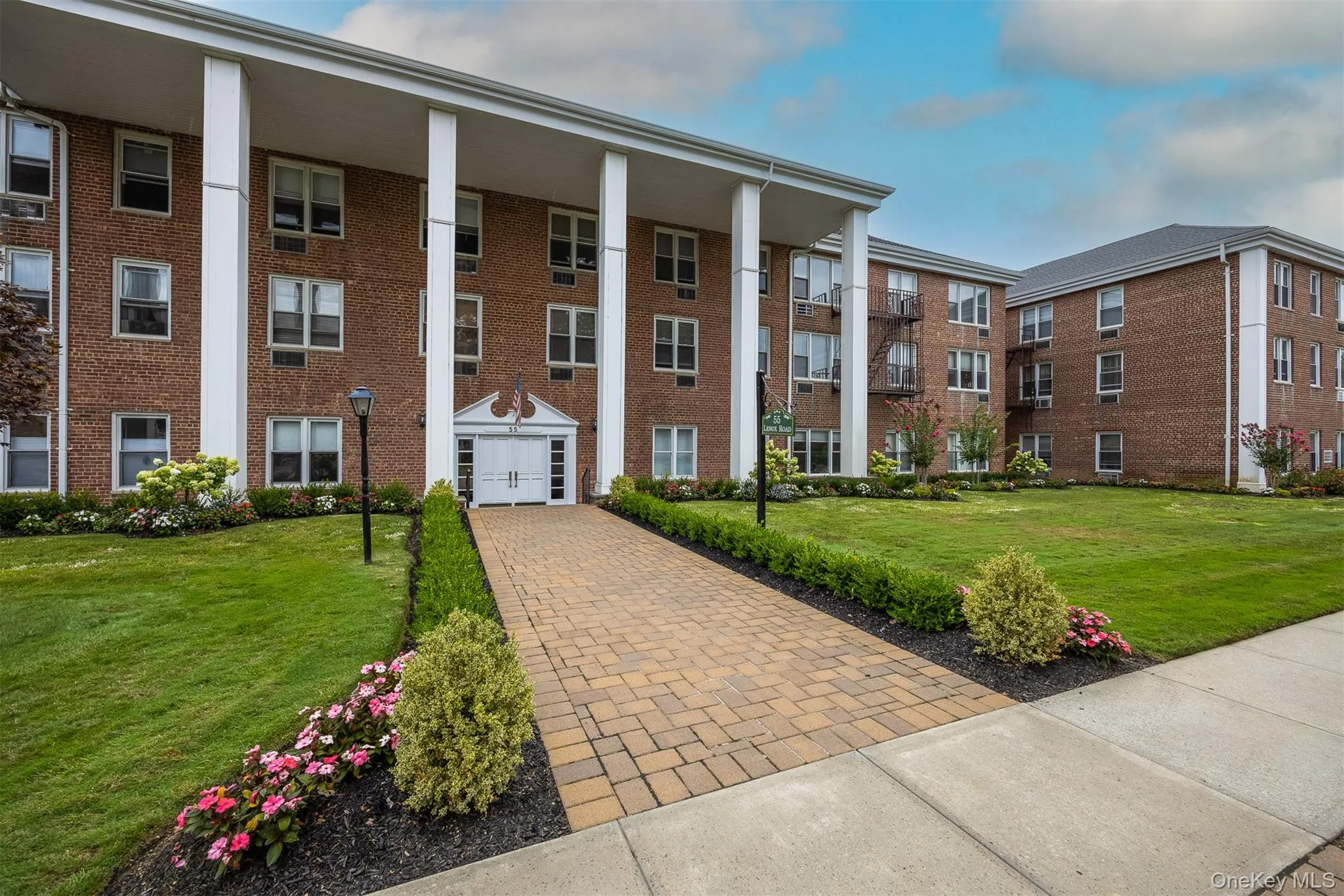 Paver walkway with manicured landscaping. Paver walkway with manicured landscaping.