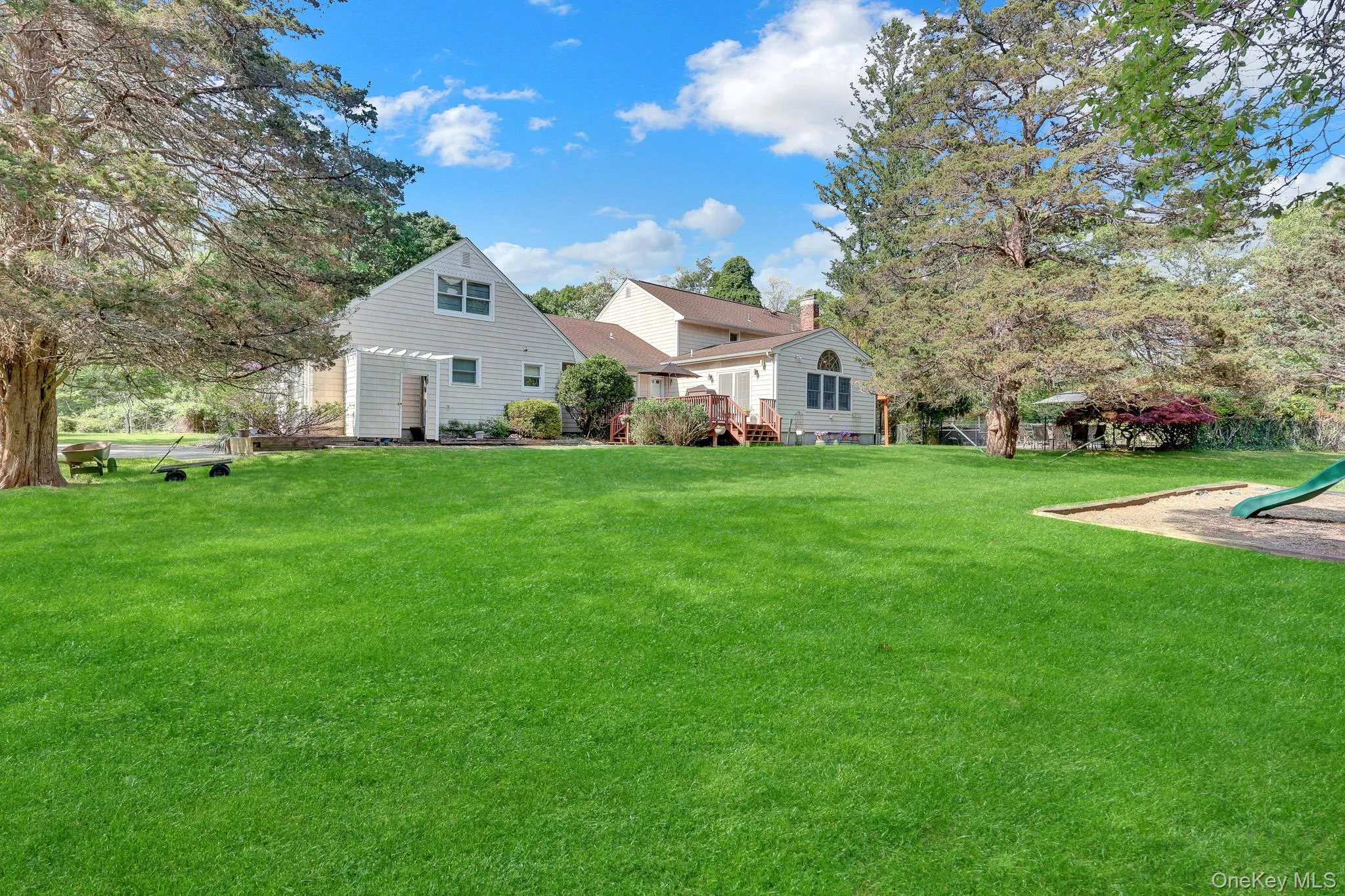 Expansive green lawn providing ample outdoor space Expansive green lawn providing ample outdoor space