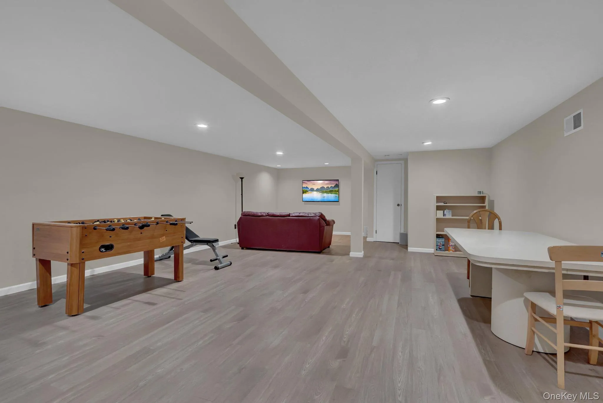 Spacious finished lower level featuring recessed lighting, light wood-finish flooring, neutral wall tones, and white trim Spacious finished lower level featuring recessed lighting, light wood-finish flooring, neutral wall tones, and white trim