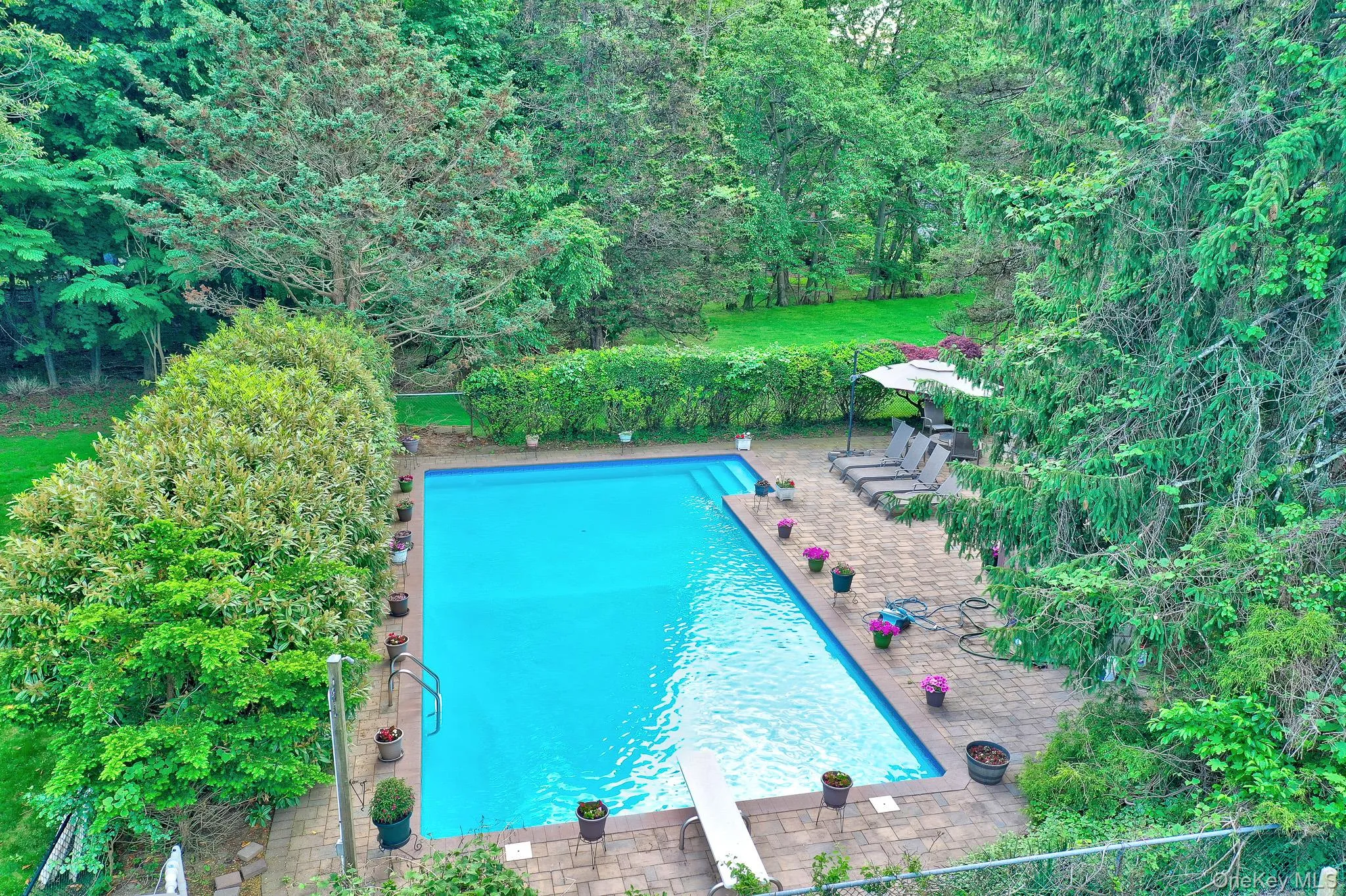 Rectangular inground pool surrounded by paver patio Rectangular inground pool surrounded by paver patio