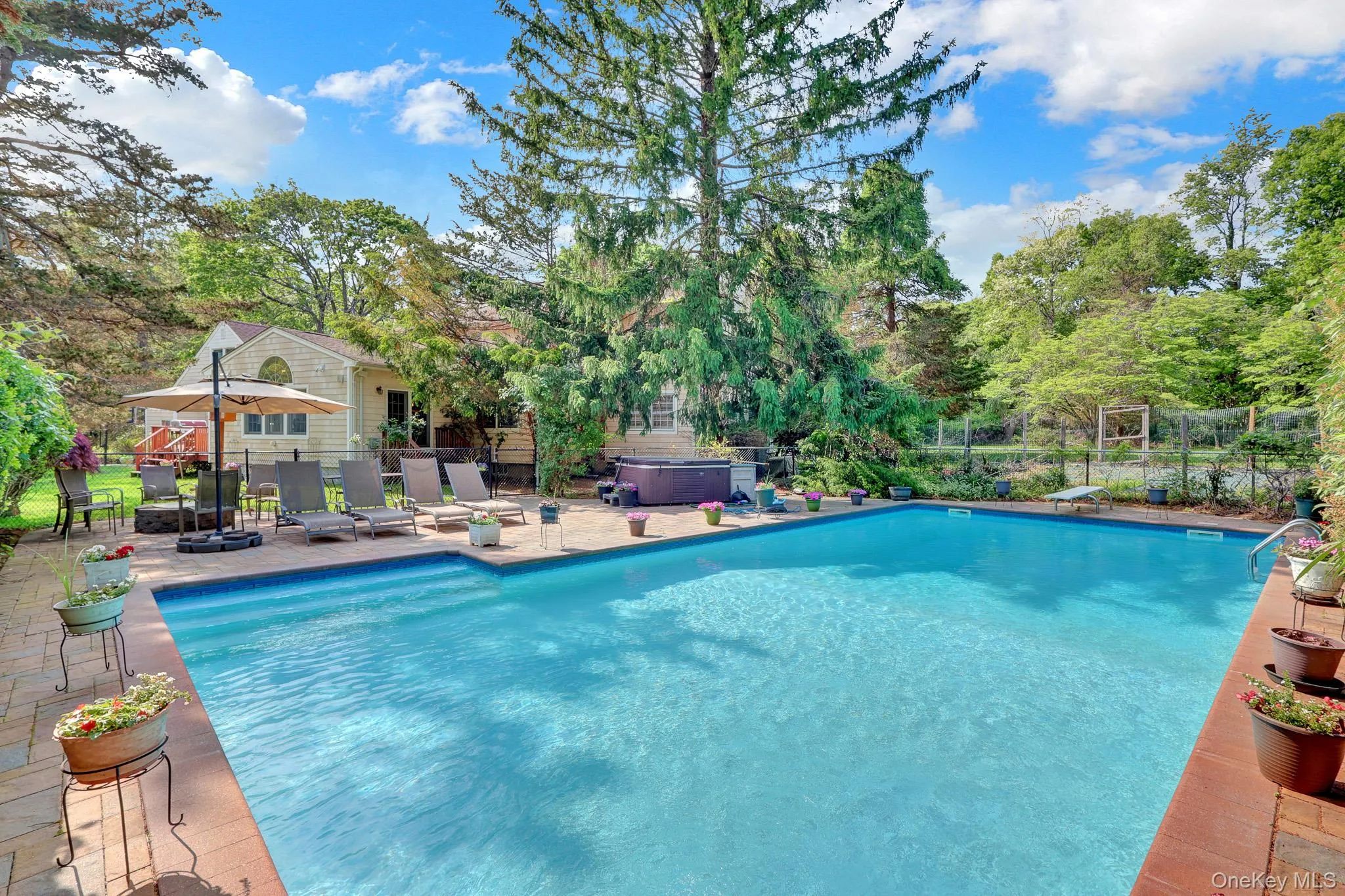 Rectangular inground swimming pool featuring integrated steps and a surrounding brick paver patio Rectangular inground swimming pool featuring integrated steps and a surrounding brick paver patio