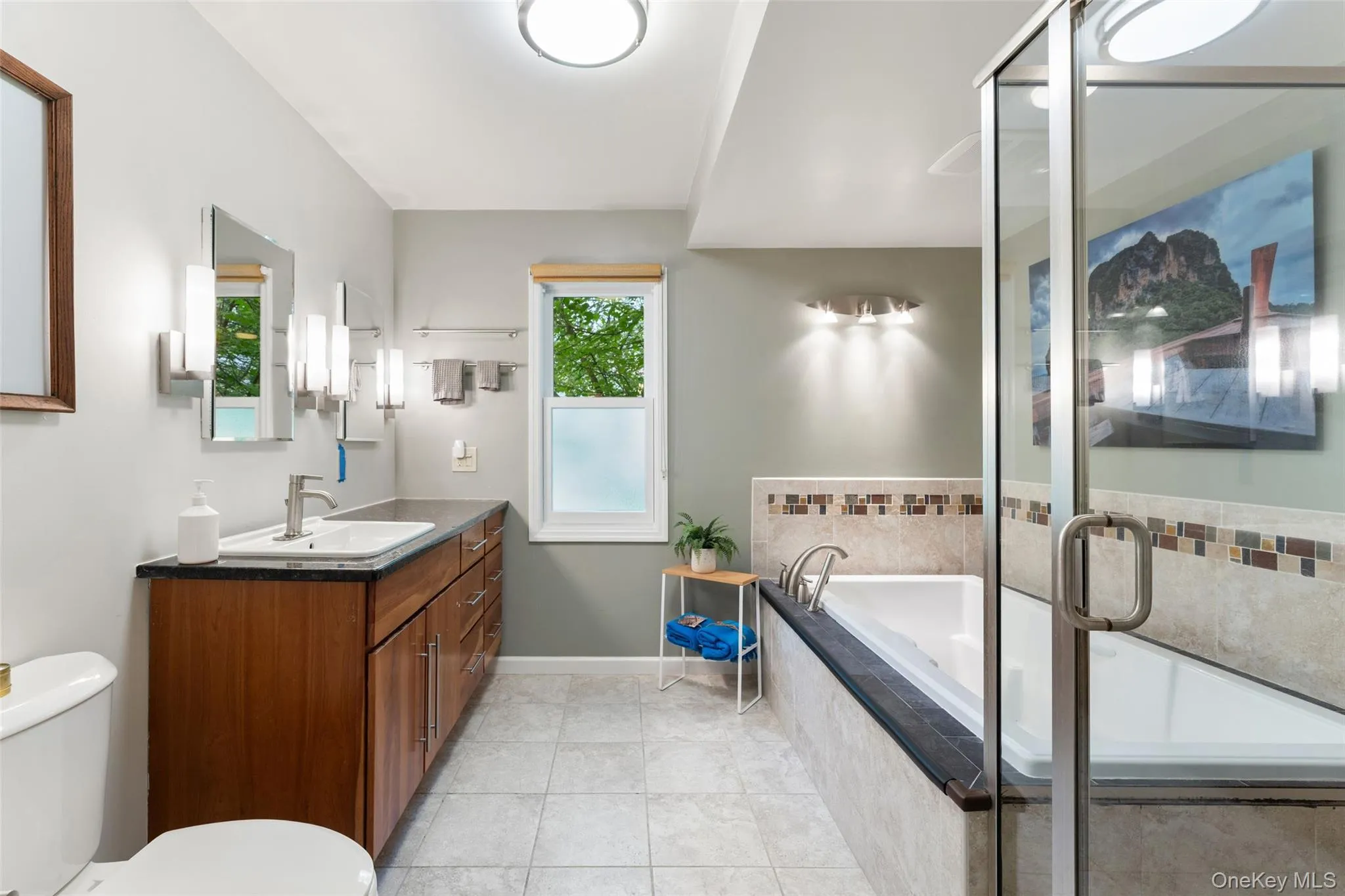 Renovated first floor primary bath with soaking tub, radiant heat and glass encased shower. Renovated first floor primary bath with soaking tub, radiant heat and glass encased shower.