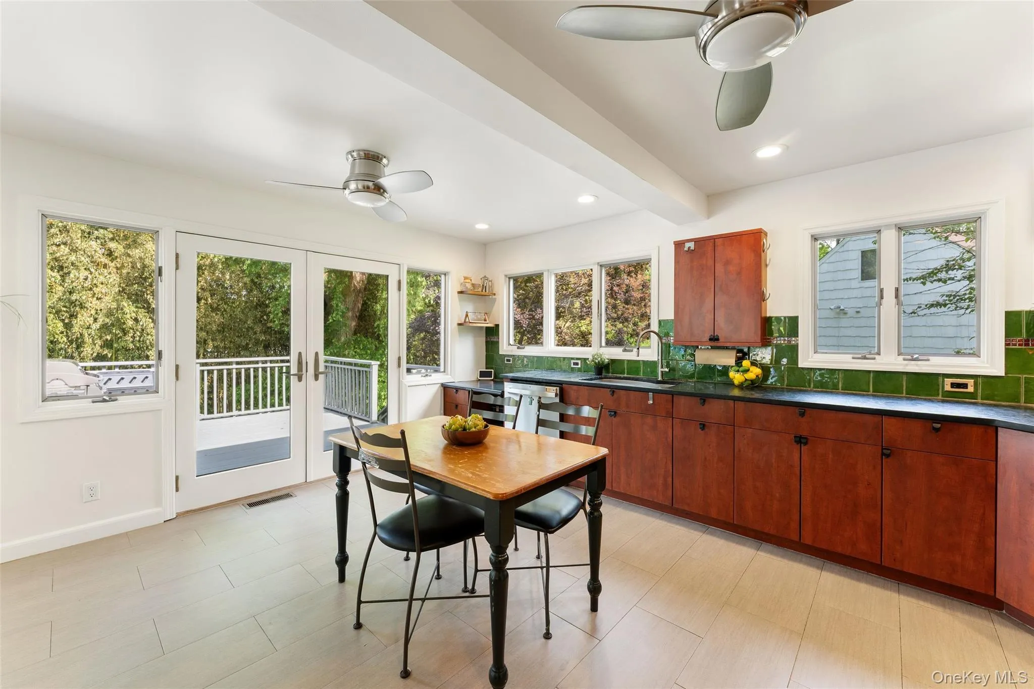 French doors from the kitchen lead to a spacious deck, perfect for outdoor entertaining. French doors from the kitchen lead to a spacious deck, perfect for outdoor entertaining.