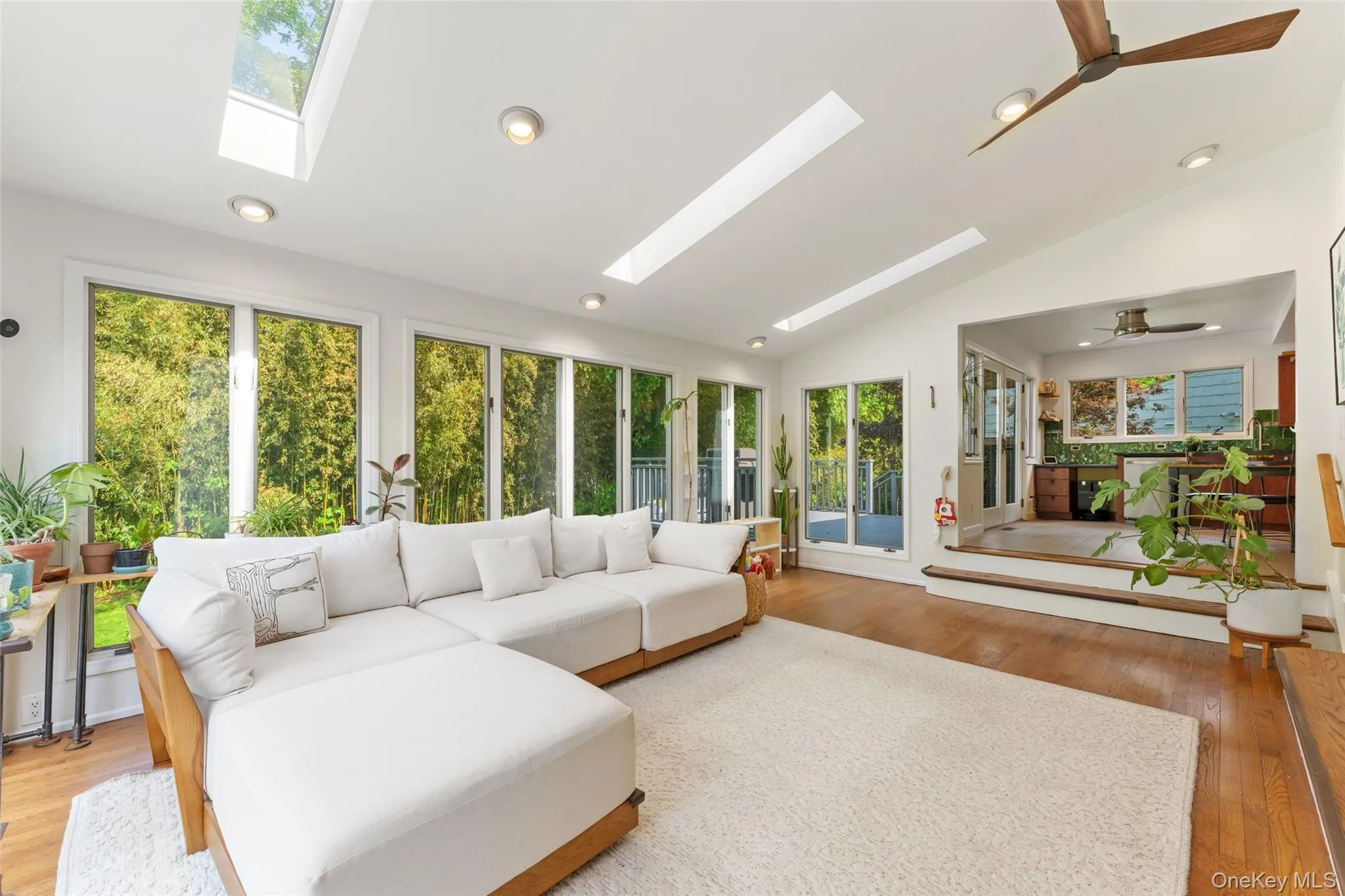 Open and inviting living room with floor-to-ceiling windows and sun-filled natural light. Open and inviting living room with floor-to-ceiling windows and sun-filled natural light.