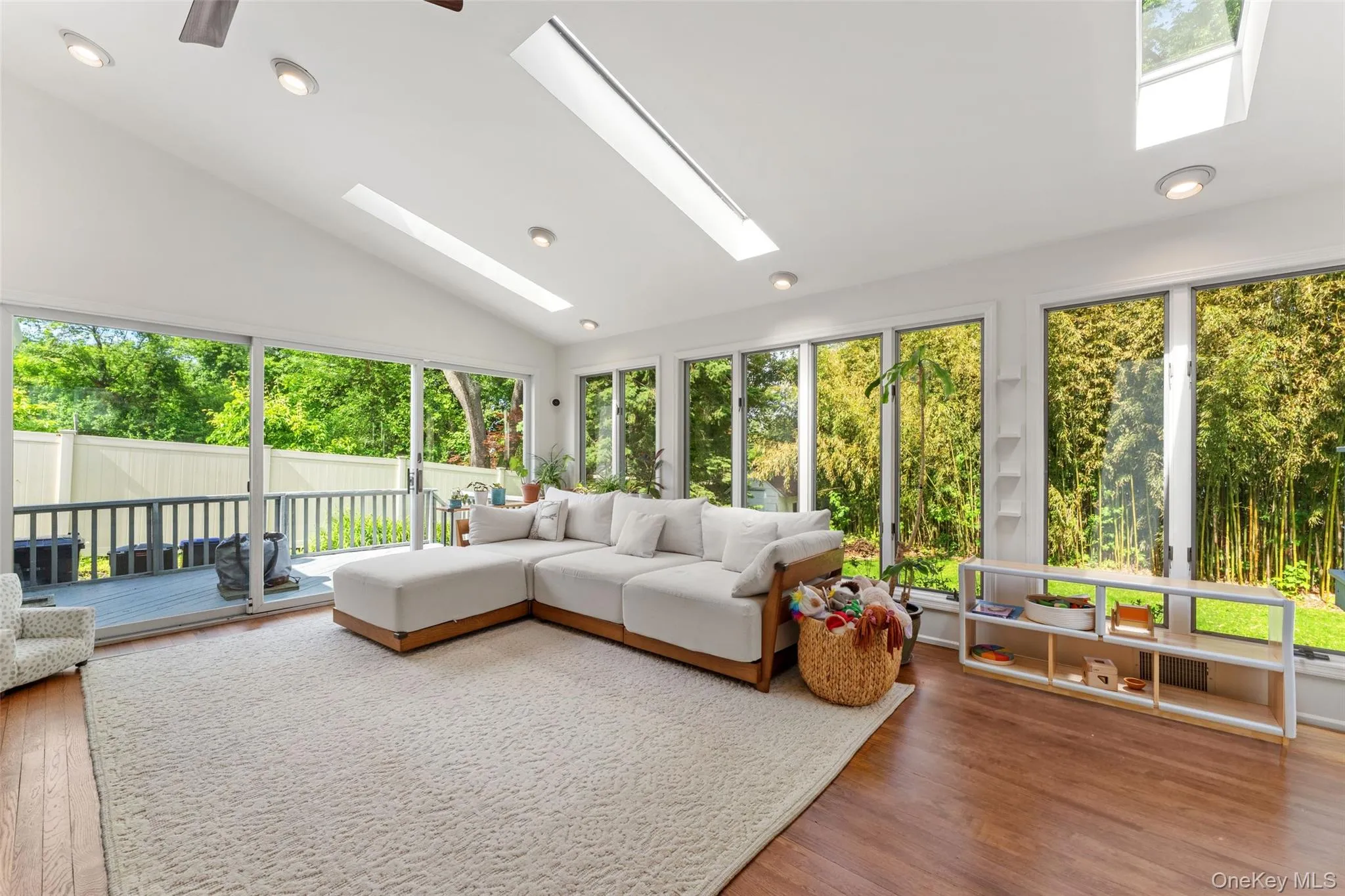 Sliding doors from the living room provide access to one of two decks accessible from the first floor. Sliding doors from the living room provide access to one of two decks accessible from the first floor.