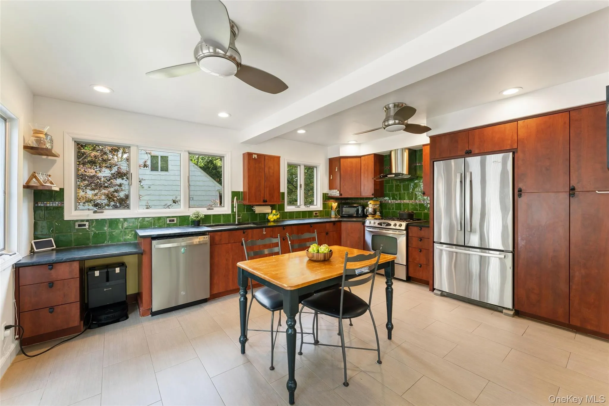 Renovated eat-in-kitchen with stainless steel appliances and workspace. Renovated eat-in-kitchen with stainless steel appliances and workspace.