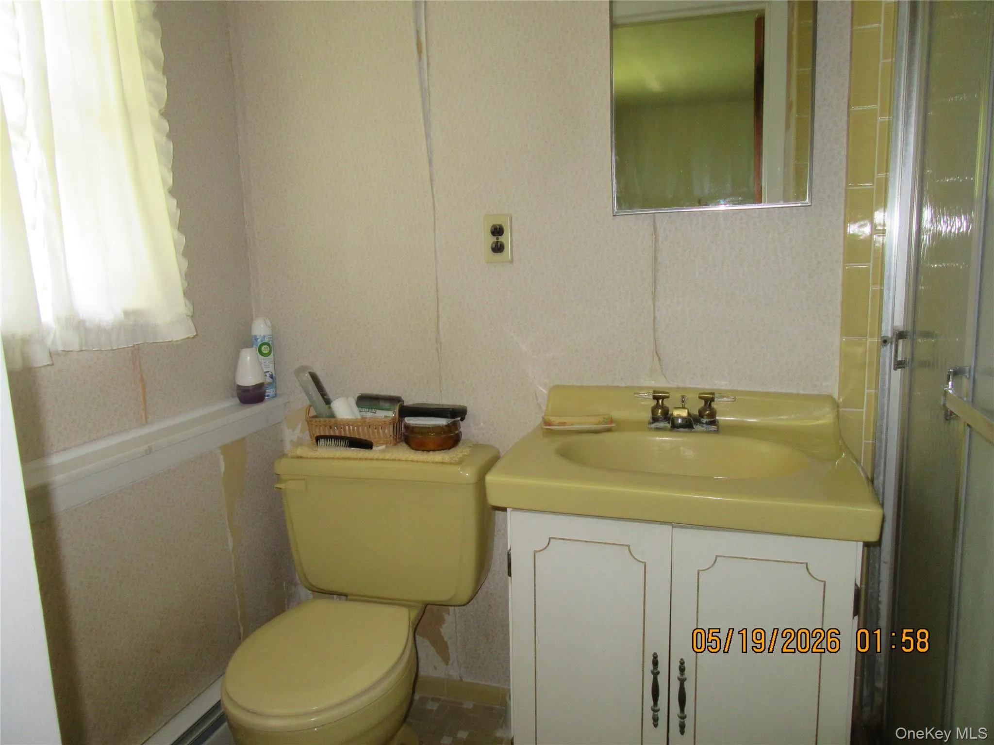 Bathroom featuring a yellow vanity with an integrated sink and a matching toilet Bathroom featuring a yellow vanity with an integrated sink and a matching toilet